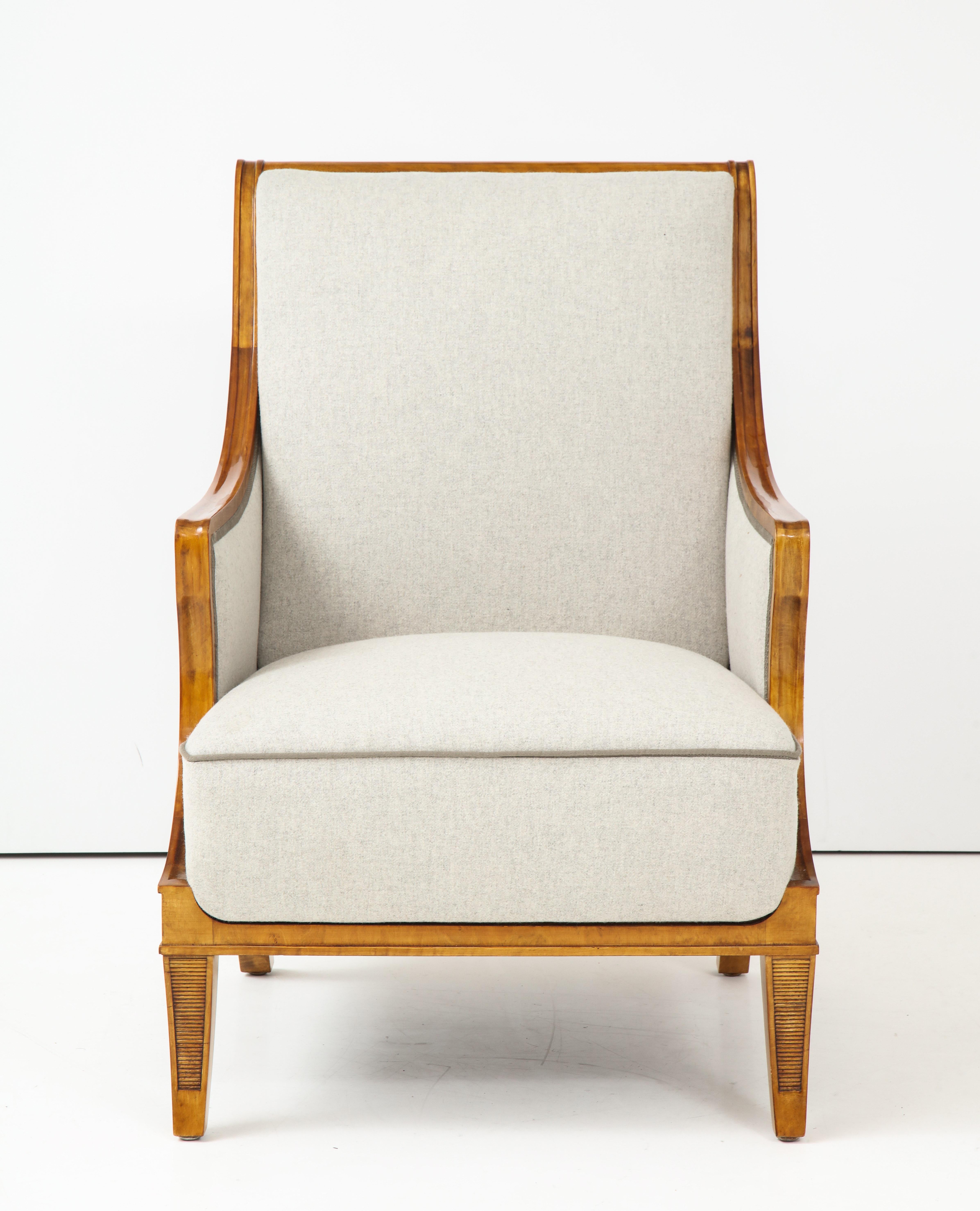 An exceptional pair of Swedish birchwood and upholstered armchairs, circa 1930s, designed by Carl Malmsten for SMF Svenska Möbelfabriken, Bodafors. Makers stamp on verso. Graceful scrolled and downswept backrests, armrests and supports, raised on