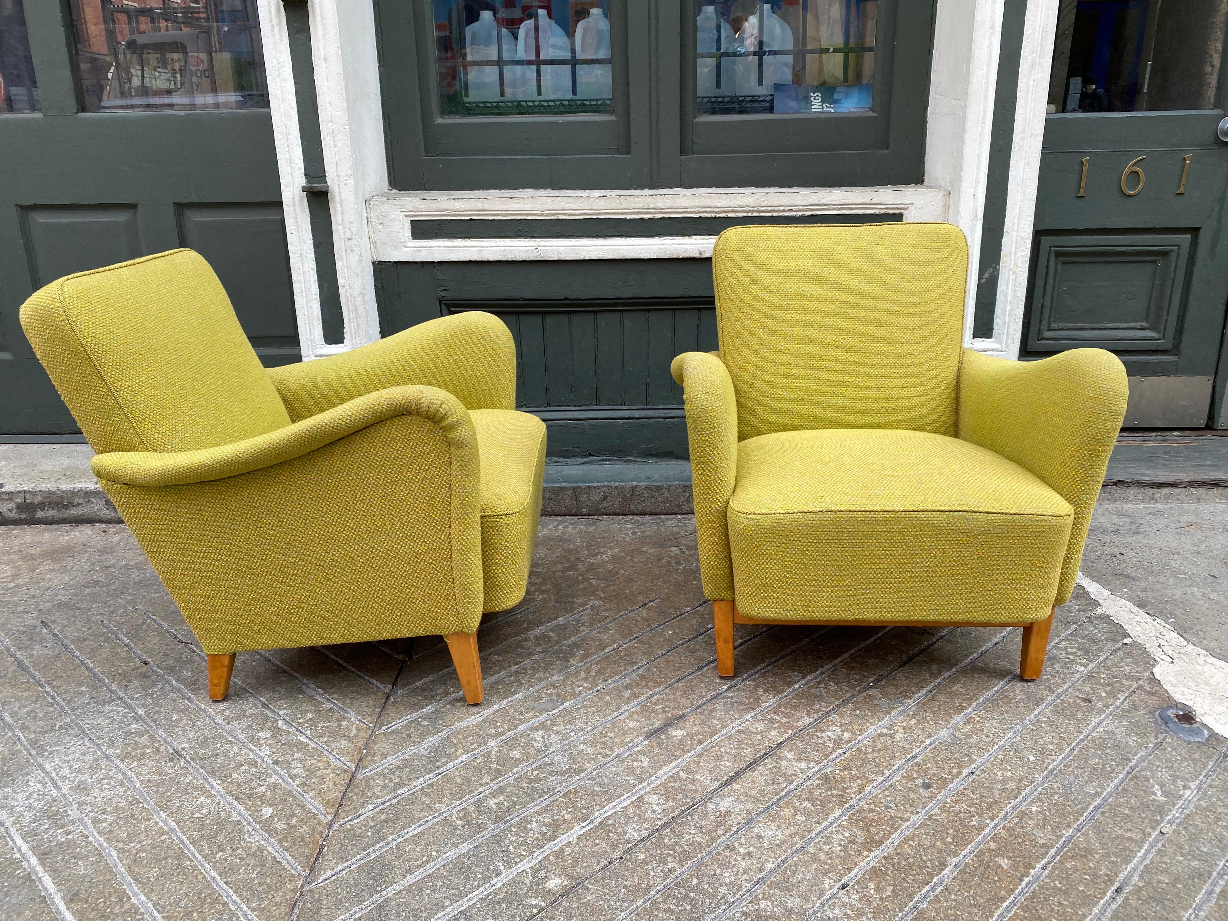 Pair of Carl Malmsten for DUX upholstered lounge chairs. Great sculptural arms that continue down the fronts of the chairs. Chairs date to the late 1940s or early 1950s Fabric is in pretty good shape, thinking they had been re-upholstered in the