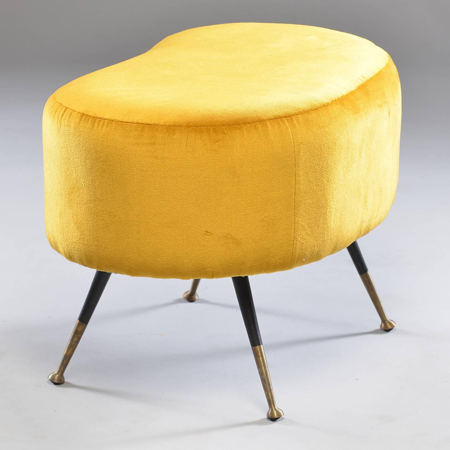 Pair of bright mustard yellow Italian kidney shaped benches or stools in the style of Carlo de Carli, circa 1960. Yellow upholstery is recent with tapered black legs and brass feet. Sold and priced as a pair. May consider splitting.
