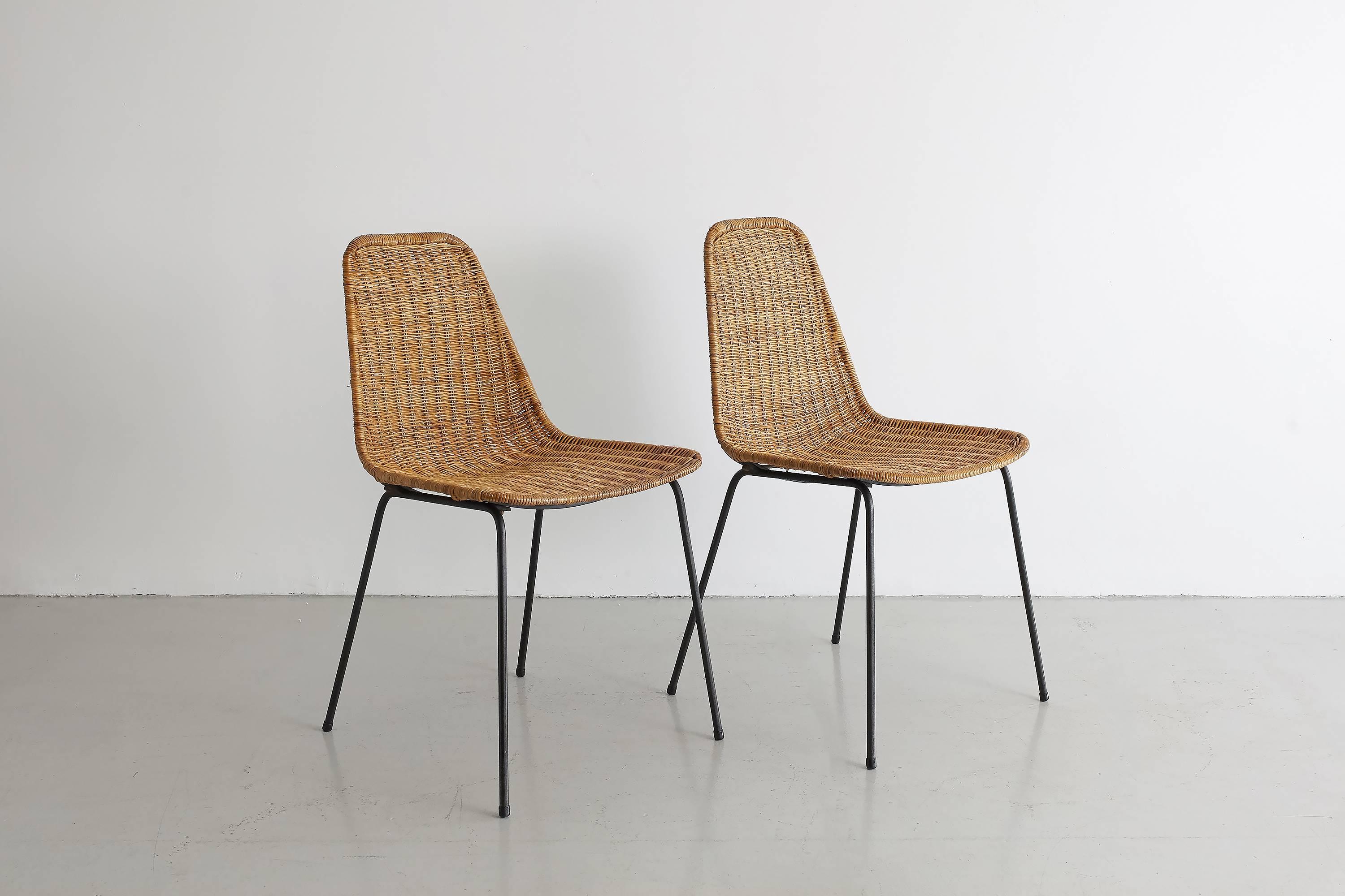 Pair of wicker chairs by Carlo Graffi & Franco Campo with inset black iron legs and bucket seats. Measures: Seat height 17