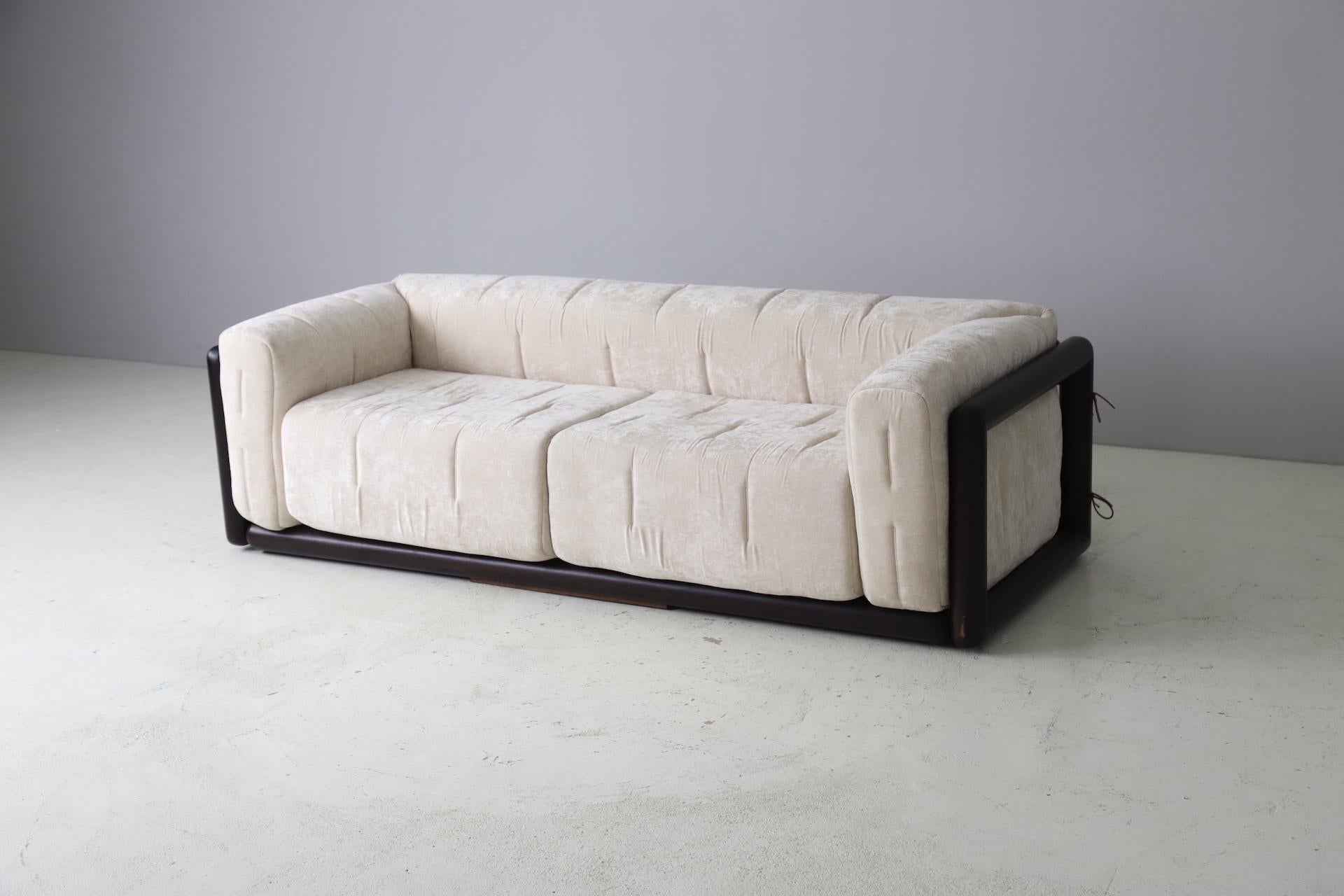 Iconic pair of Cornaro sofas designed by Carlo Scarpa , Italy 1973. Made out of solid dark stained iroko wood with new velvet upholstery and foam. The cushions are fixed to the wooden frame with leather laces. 

Carlo Scarpa (2 June 1906 – 28