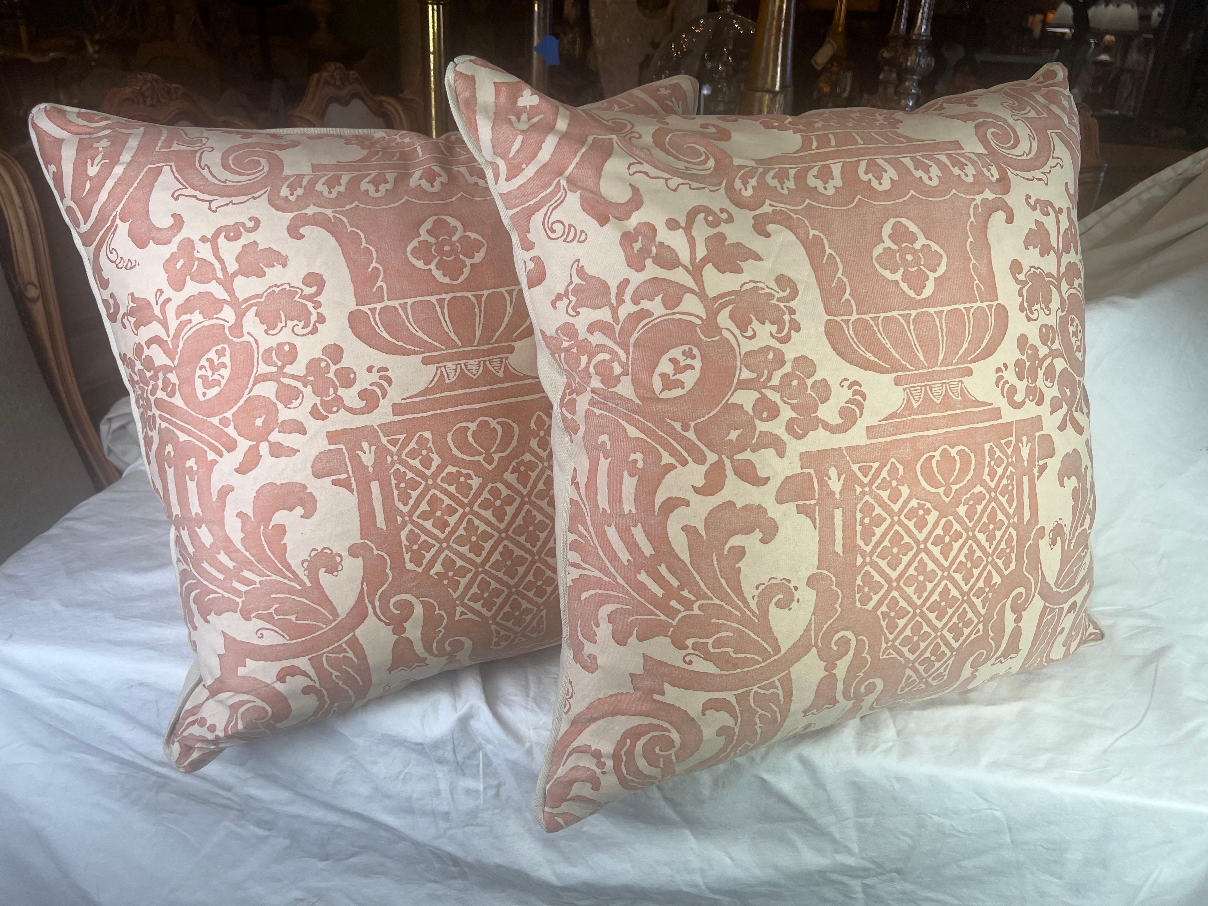 Pair of custom Carnavalet patterned Fortuny textile pillows in pink & cream. The 17th Century inspired French design-with magnificent and intricate garden urns abundant with flowers-is framed by lavish cornucopia & elaborate scrolling swags.