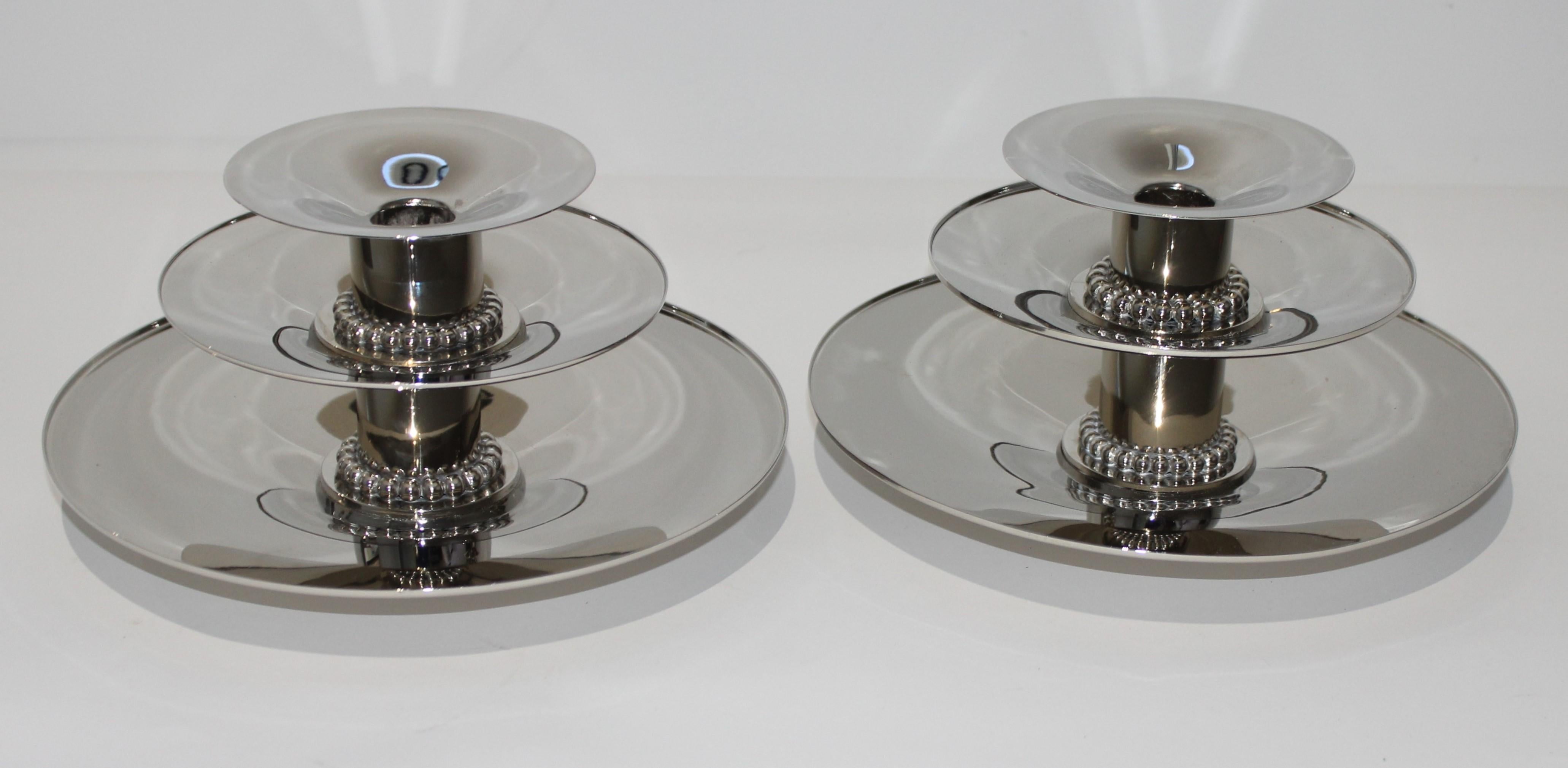 This stylish pair of Carole Stuppell Art Deco candleholders date to the 1930s and have recently been restored with a nickel plated finish.

The can be used solely as candleholders or perhaps with a candle and cut flowers on the two lower