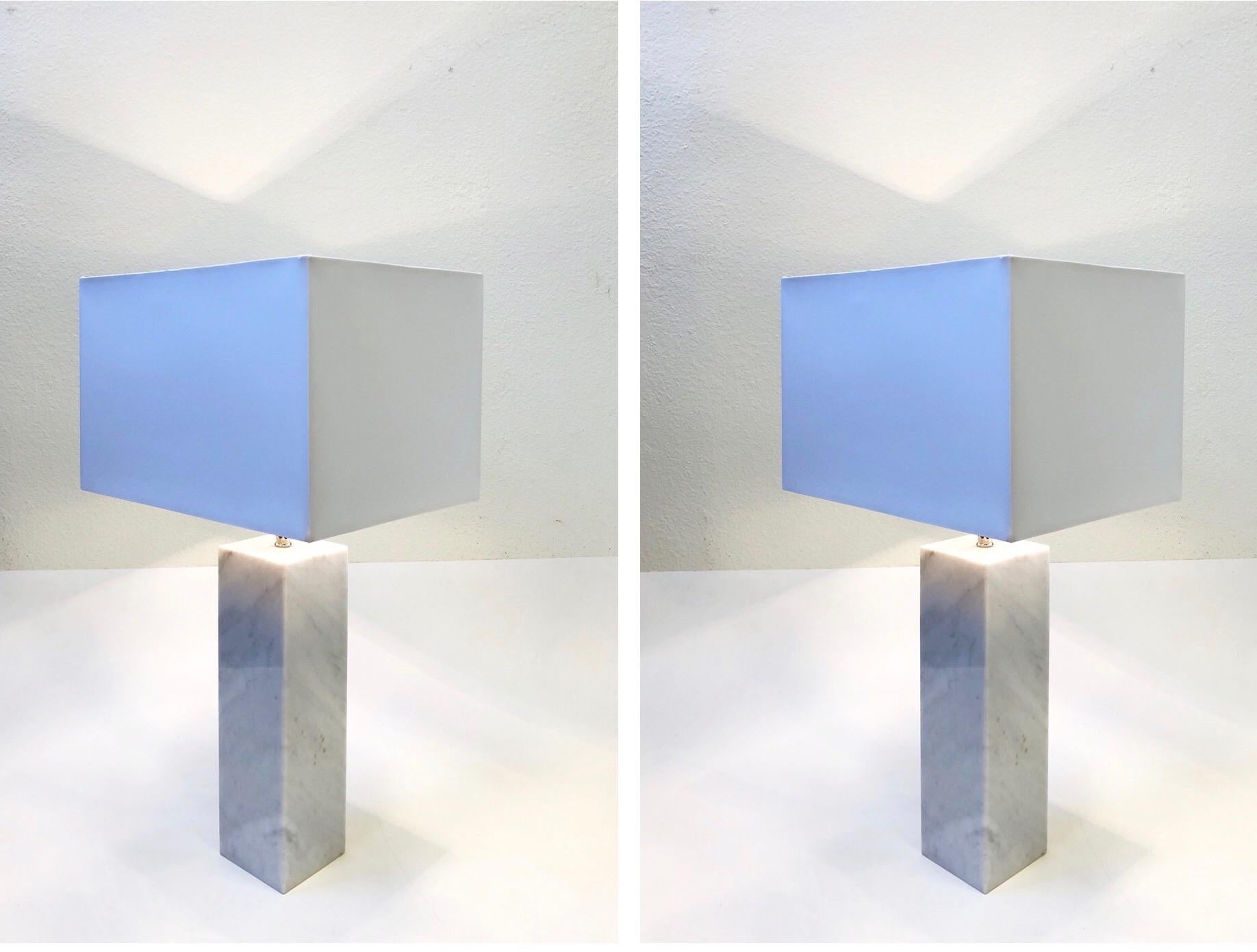 A beautiful pair of Carrara marble and polish nickel table lamps designed by Nessen in the 1960s.
The lamps are solid marble. Newly rewired and new shades. The shades are white on outside and metallic silver in the inside.
Overall dimensions: