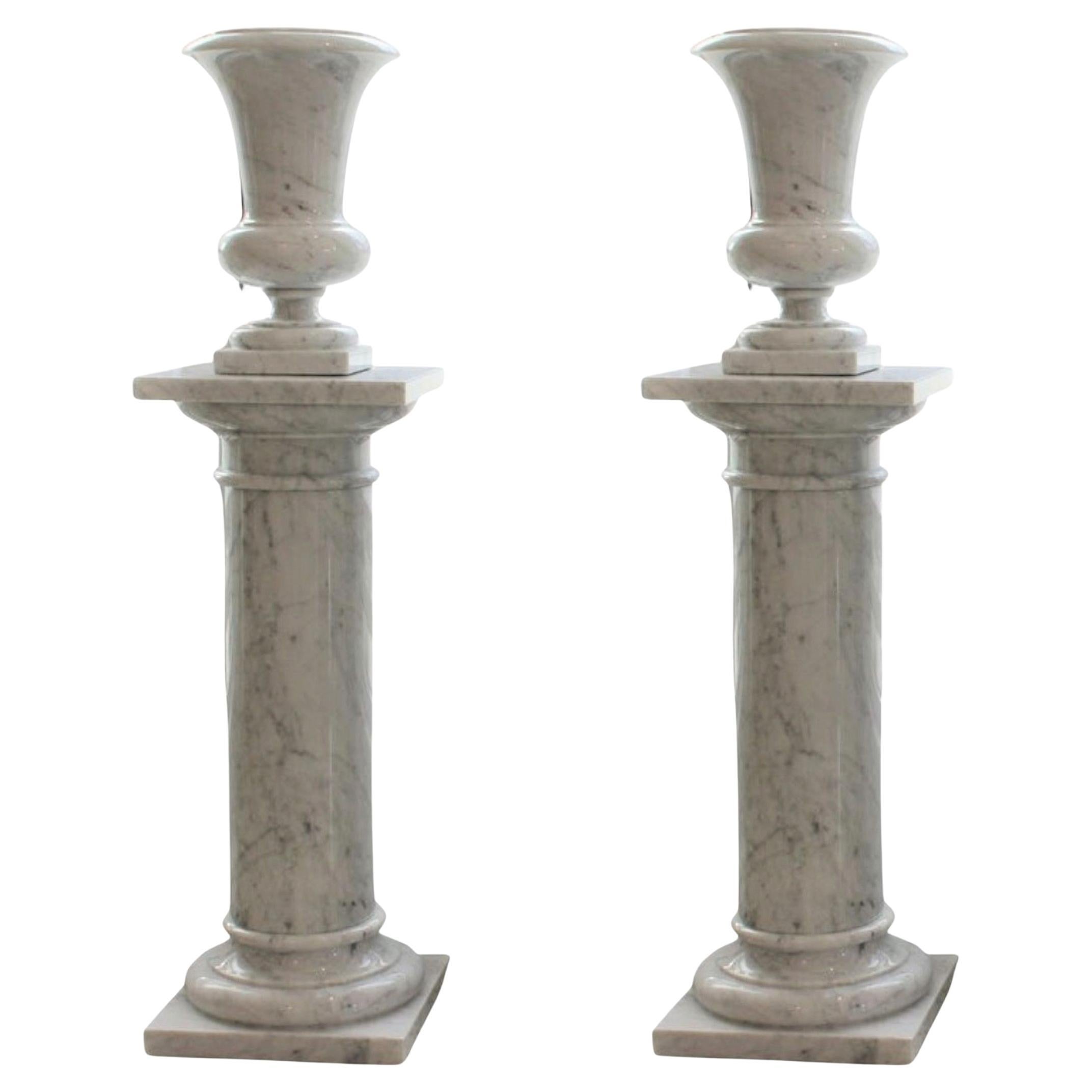 This stylish and chic pair of carrera marble urns on stand were acquired from a Palm Beach estate.  The pieces will make a statment with their form and use of materials.

Note: The urns are not affixed to the bases.

Note: The urns measure