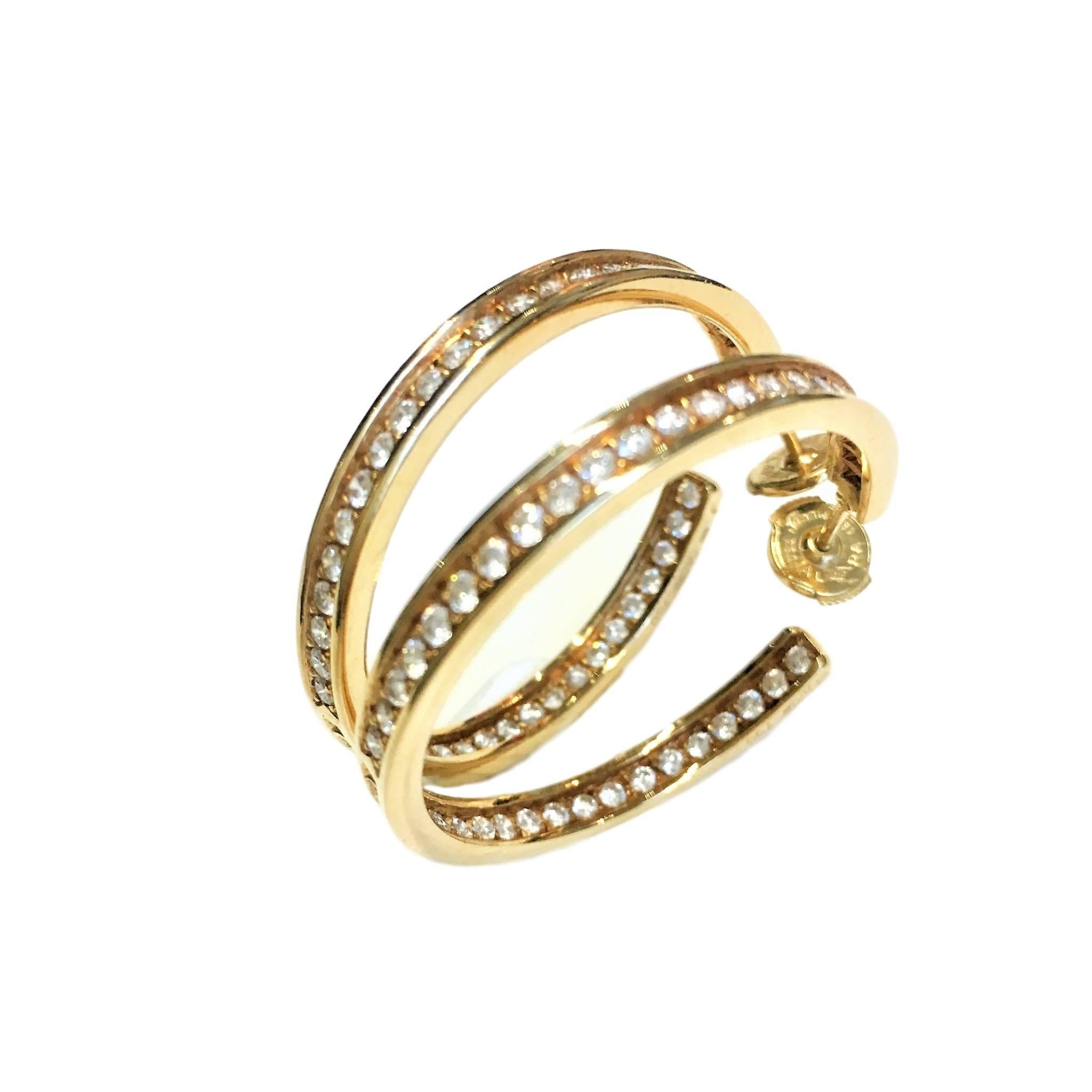18k yellow gold Cartier diamond hoop earrings. Each set with round brilliant cut diamonds.
Total weight of approximately 3ct,  The earrings measure 34mm in height and 2.5mm in width and 
Posts with alpa back fittings. 
Signed Cartier. Numbered.