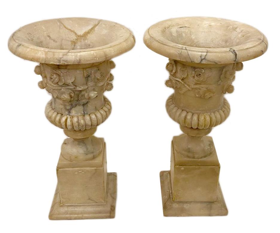 Pair of circa 1930s Italian carved alabaster urns with an interior light.

Measurements:
Height of body 16