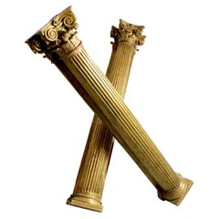 Pair of carved and gilded wall columns with fluted shafts and capitals topped