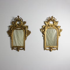 Pair of carved and gilded wooden mirrors