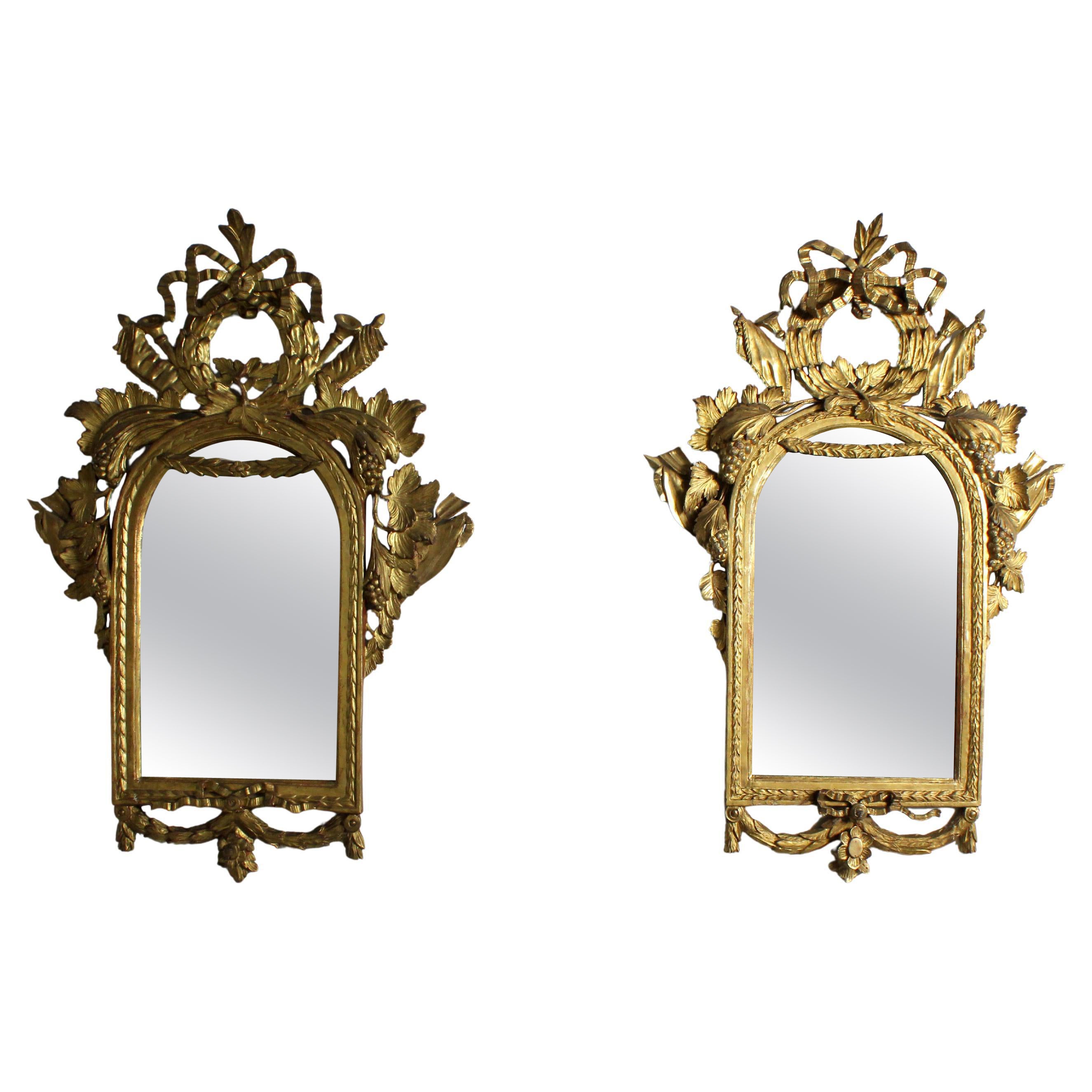 Pair of carved and gilded wooden mirrors For Sale