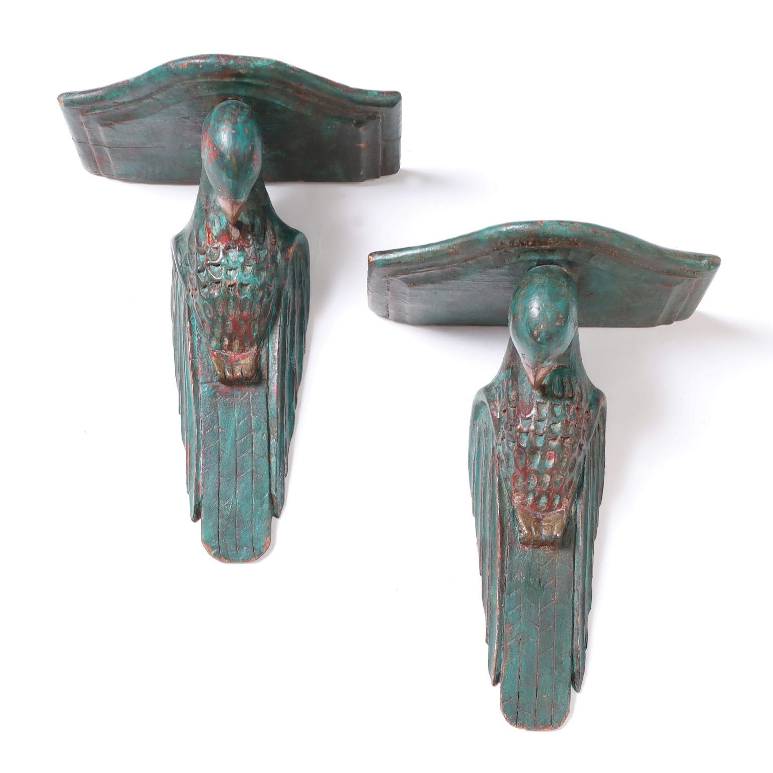 Antique pair of Anglo Indian Art Deco brackets or wall shelves carved from indigenous hardwood and painted over red primer now worn to perfection.