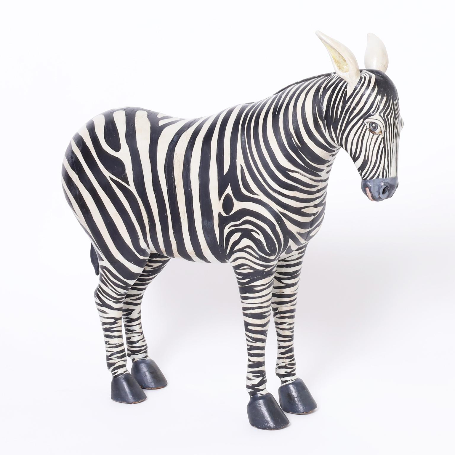 Striking pair of mid century zebra models hand carved in hardwood and hand decorated with the iconic zebra stripes.