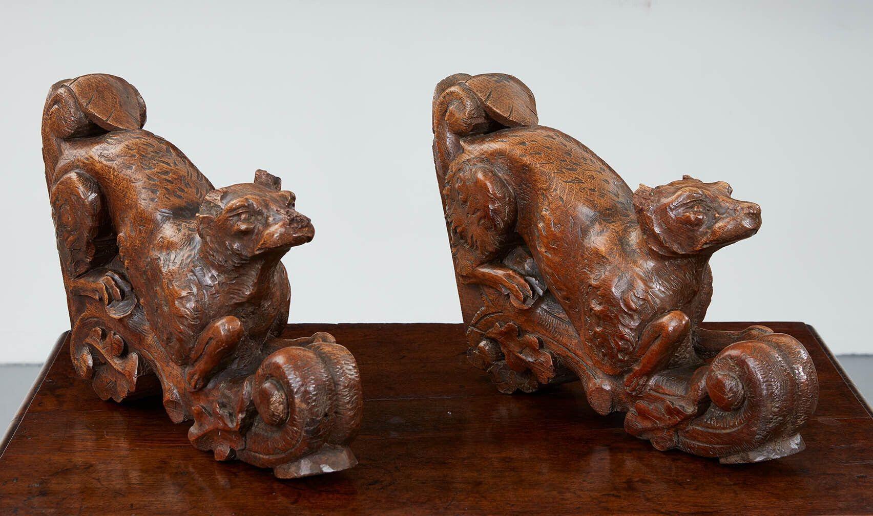 A pair of Arts & Crafts brackets hand-carved in the shape of pouncing foxes on oak branches. Originally bench or table brackets, they have developed marvellously worn and tactile surfaces. Heavy and substantial. Would make a decorative and unique