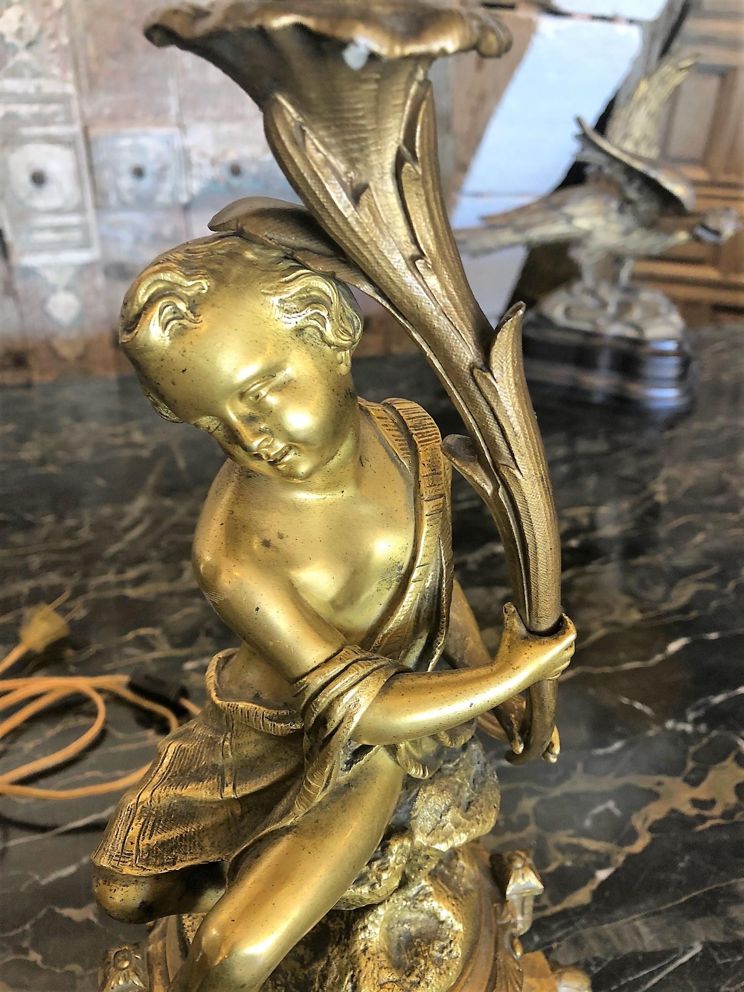 Here we have a pair of French lamps made of polished bronze depicting exquisitely detailed carvings, each sitting atop a marble base, 

circa 1890.

Origin: France

Measurements:
7