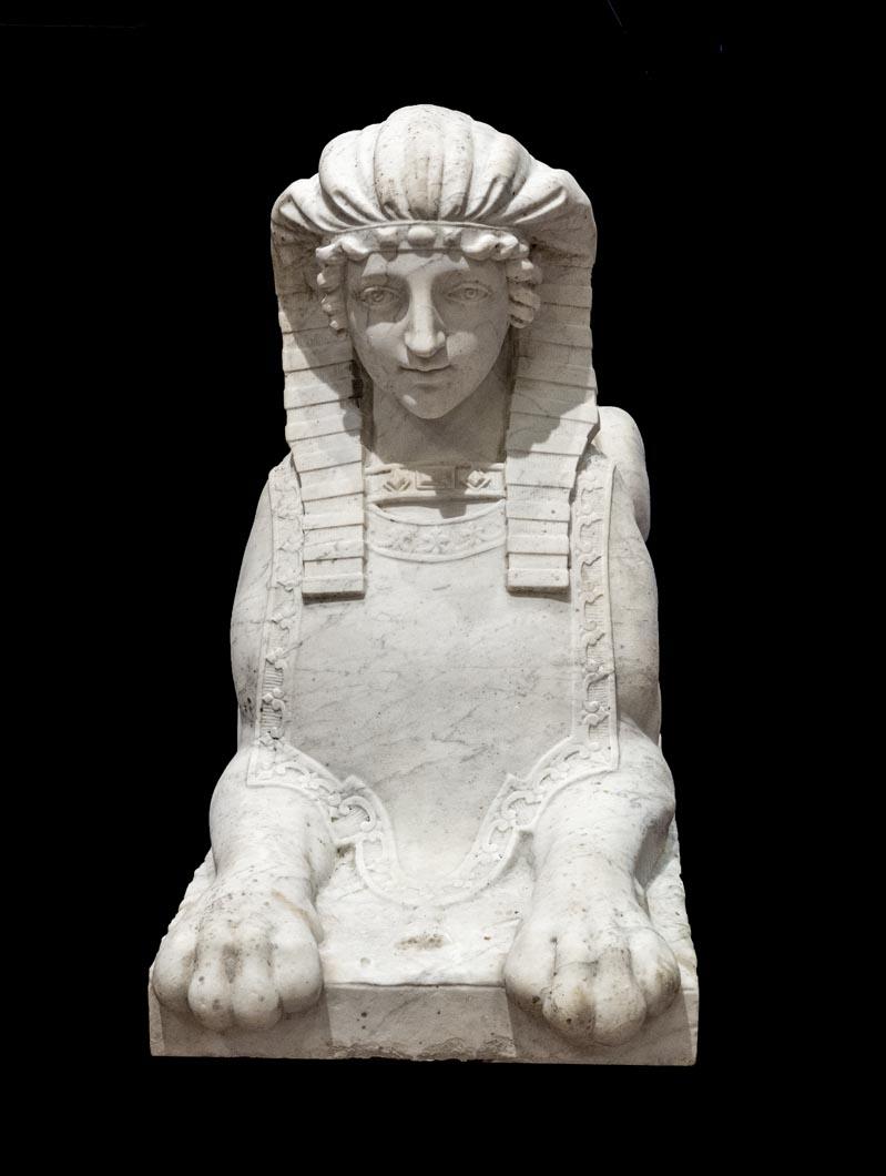 Exceptional pair of white Carrara marble Sphinxes on rectangular bases. A very noble female bust combined with the powerful body of a lioness, recumbent with her tail lying flat on her back.
The sphinxes wear “nemes”, the most emblematic headdress