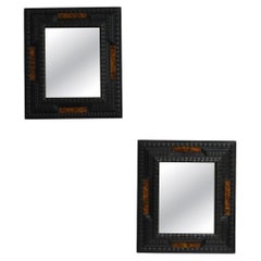 Pair of carved ebonised wood and trompe l'oeil turshell mirrors, XIXth c.