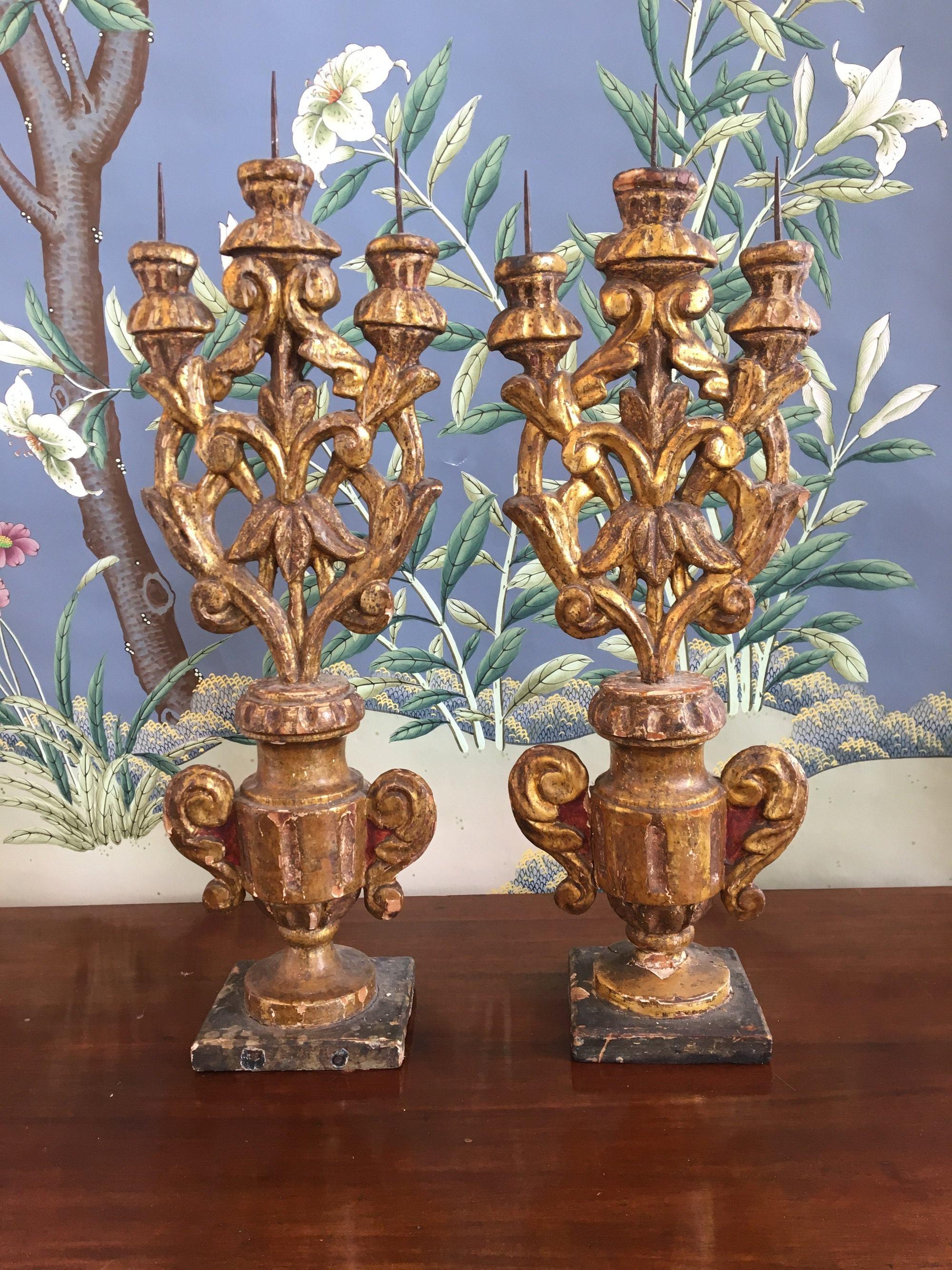 Pair of early carved and gilt wooden pricket candelabra, 18th century, likely Italian.