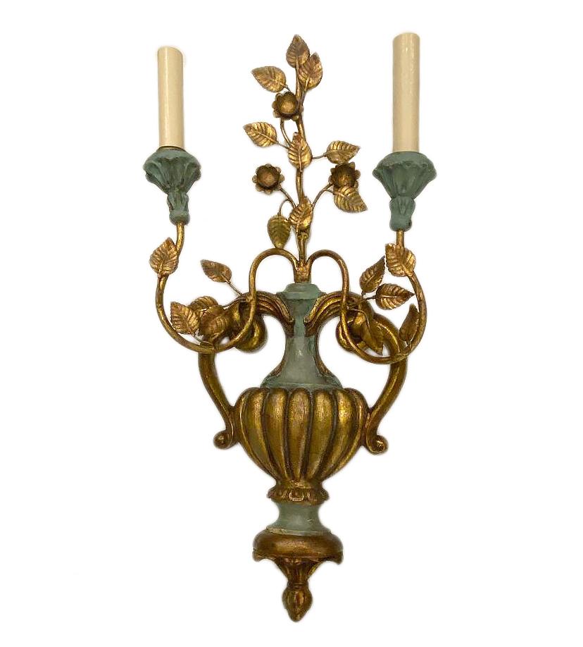 Pair of circa 1940s two-arm Italian carved and giltwood sconces with original painted finish and with gilt metal foliage motif crowning the body. 

Measurements:
Height 23