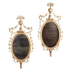 Pair of Carved Giltwood Neoclassical Oval Mirrors