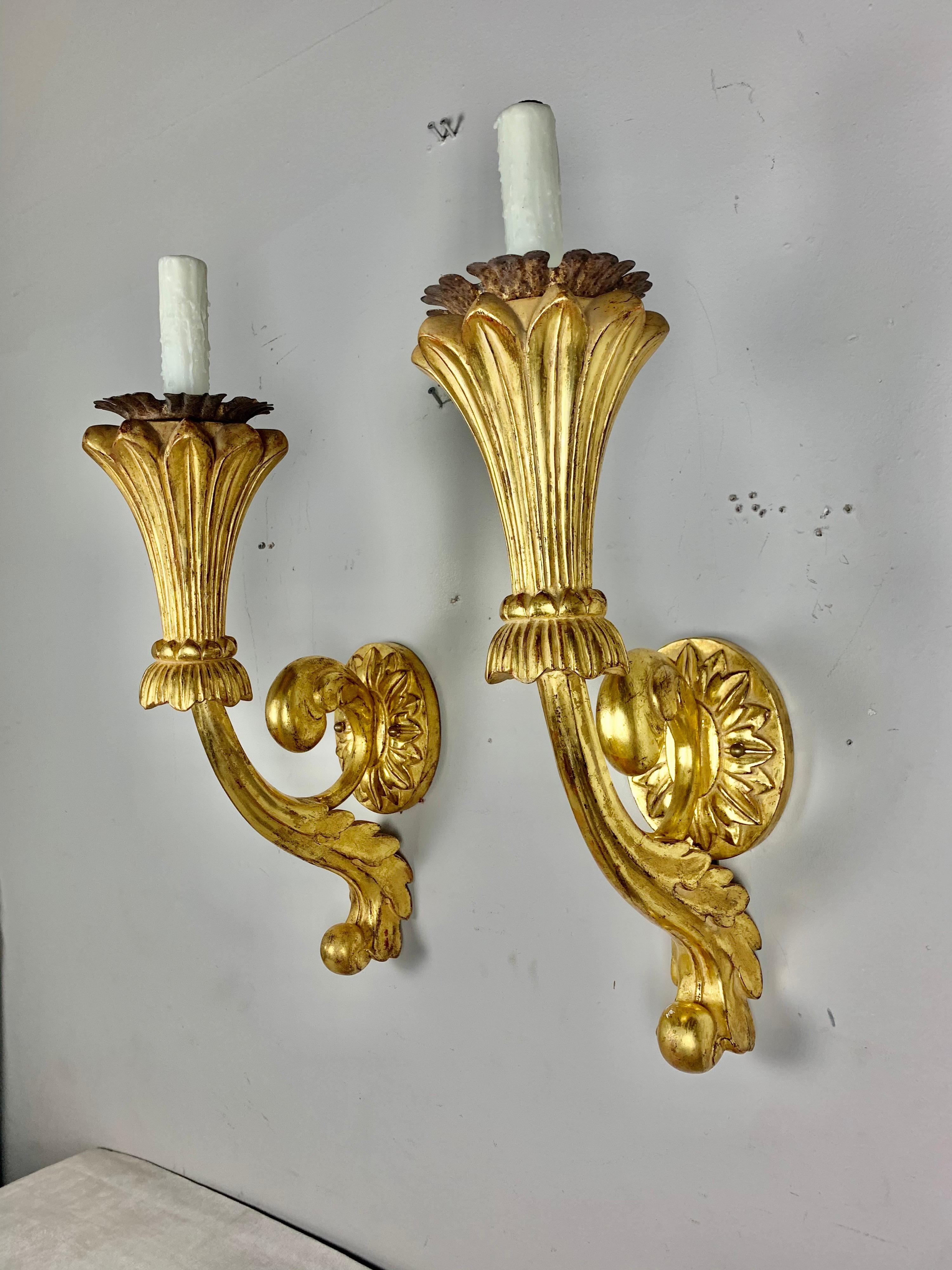 Pair of carved giltwood Italian style sconces with wrought iron bobeches. The sconces are newly rewired and ready to install.