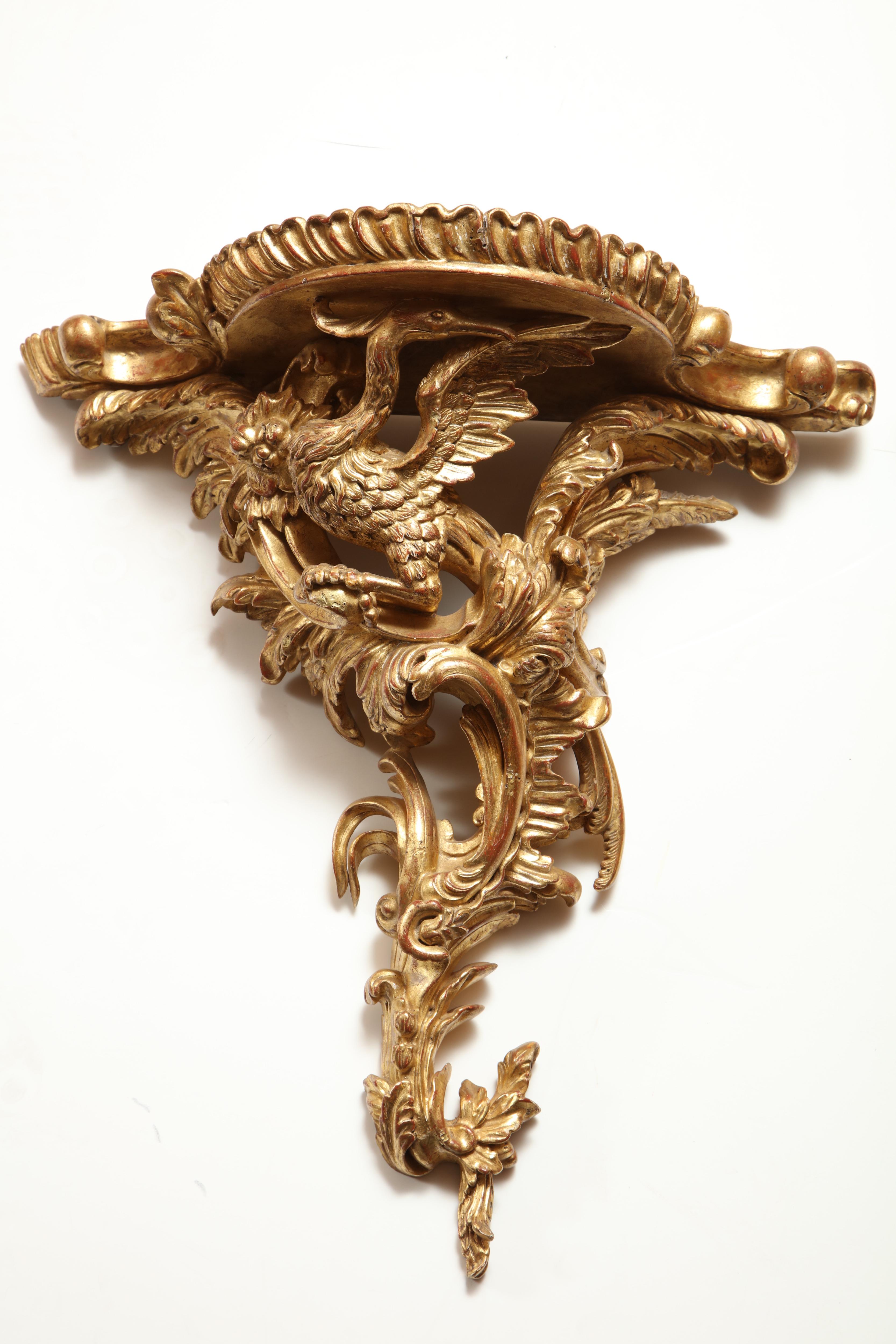 A fine pair of Chippendale carved giltwood wall brackets of phoenix birds perched on acanthus leaves.