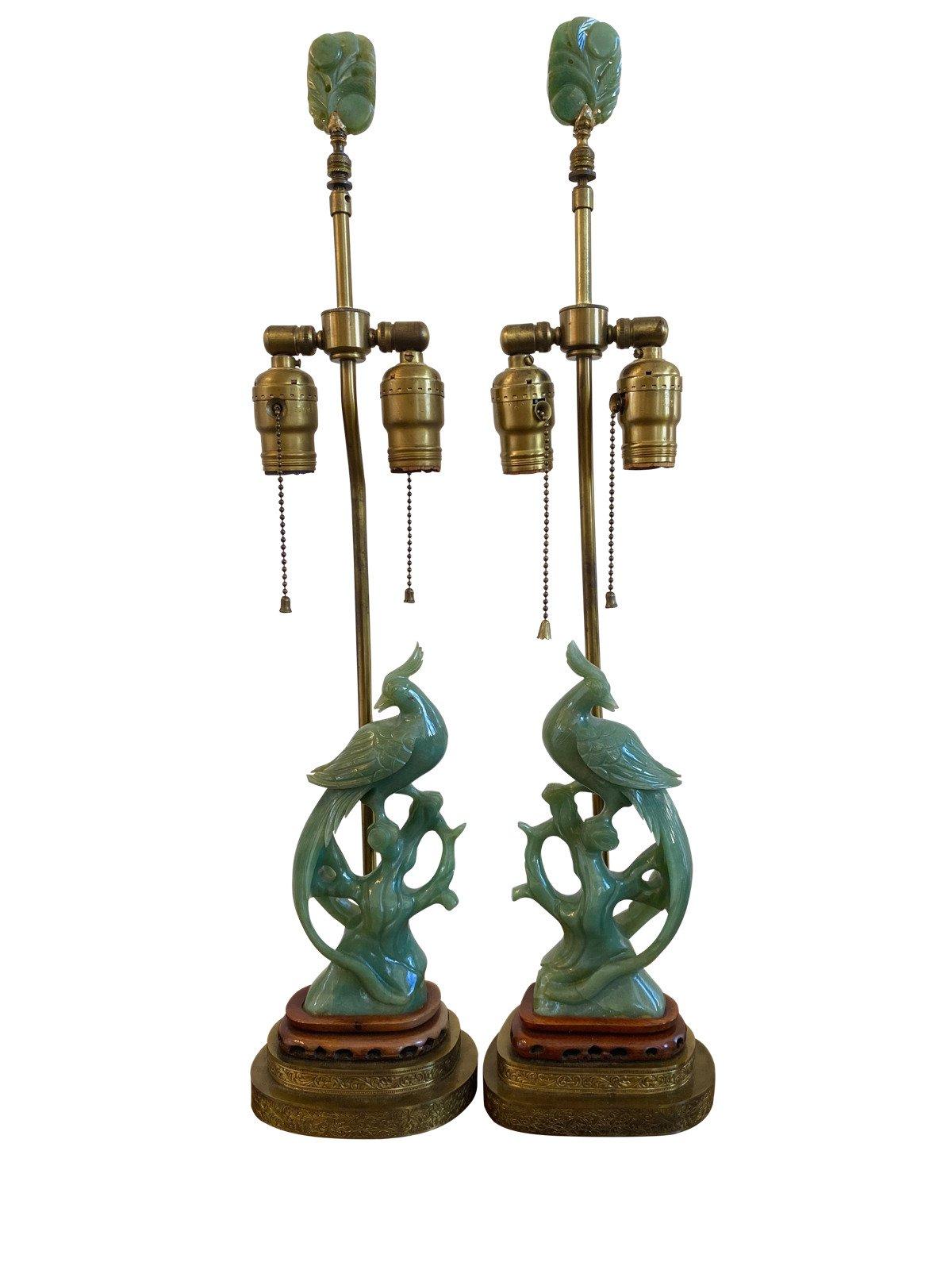 Pair of late 19th-early 20th century carved jade phoenix form lamps, lamp 26” H., phoenix figure 9.5” H. S 5” W x 2” D, lamp base approx. 6” x 4”. With black silk shades.