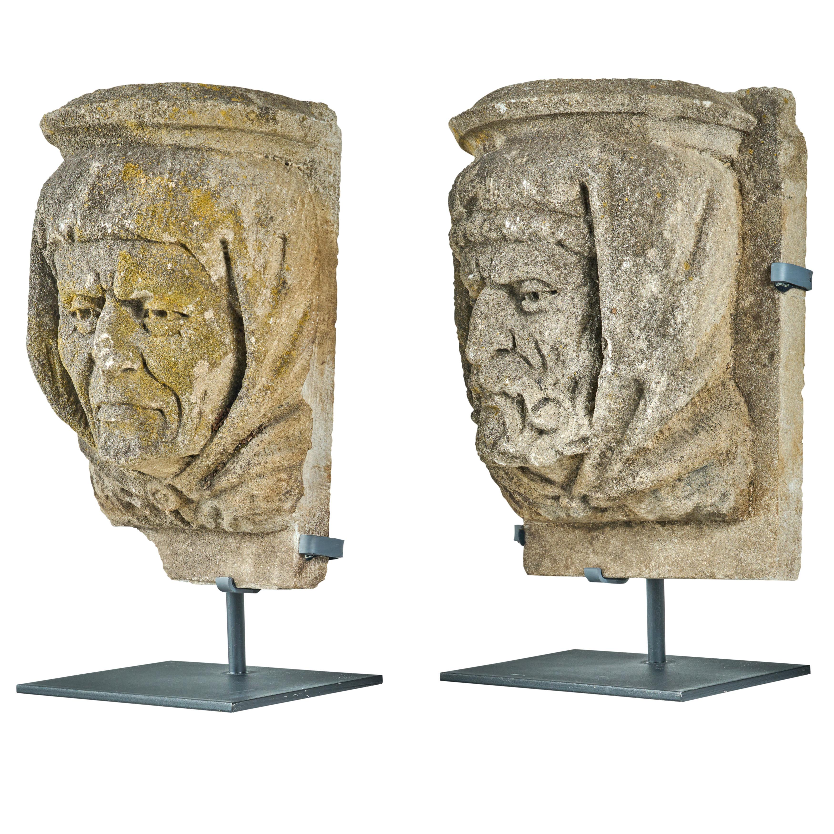 Pair of carved limestone heads from a Chicago Hospital. Heads depict ancient medical practitioners. Custom iron mounts are recently made.
