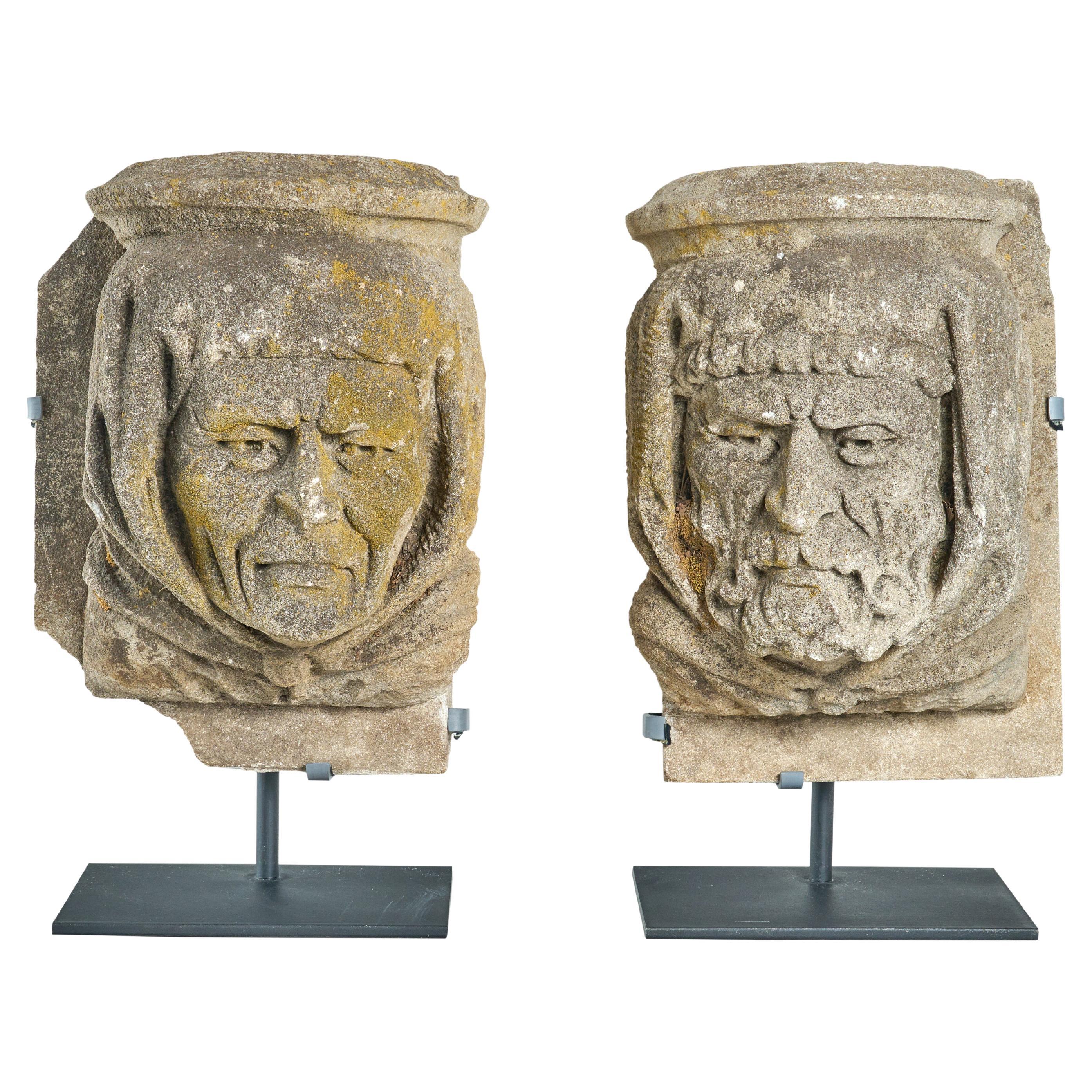 Pair of Carved Limestone Heads from a Building Facade For Sale