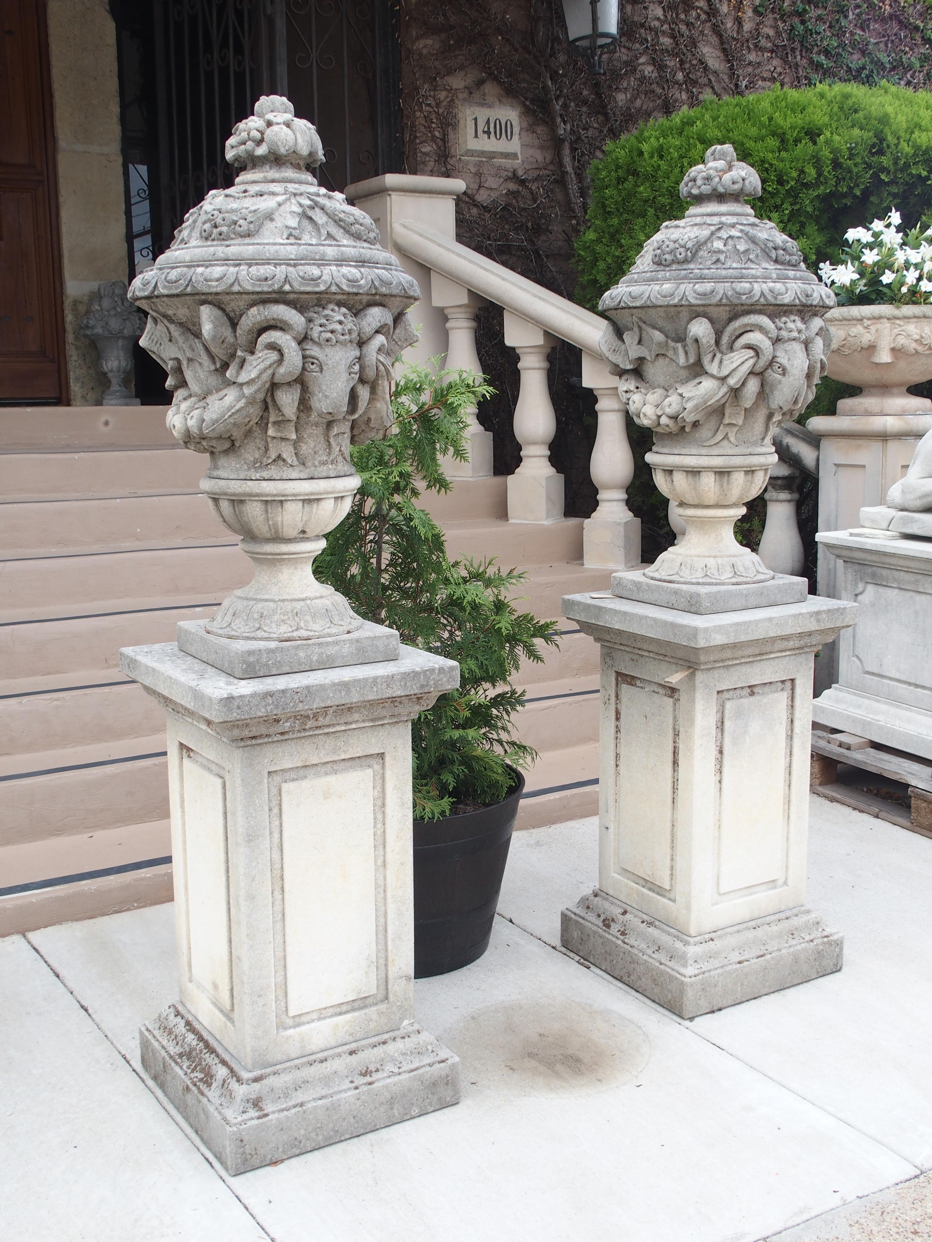 Made from individually carved pieces of Italian limestone, this pair of rams’ heads vases on pedestals make quite an impression. The intricacies of each carving indicate that a true master carved these.

Each vase is topped by a fruit and floral