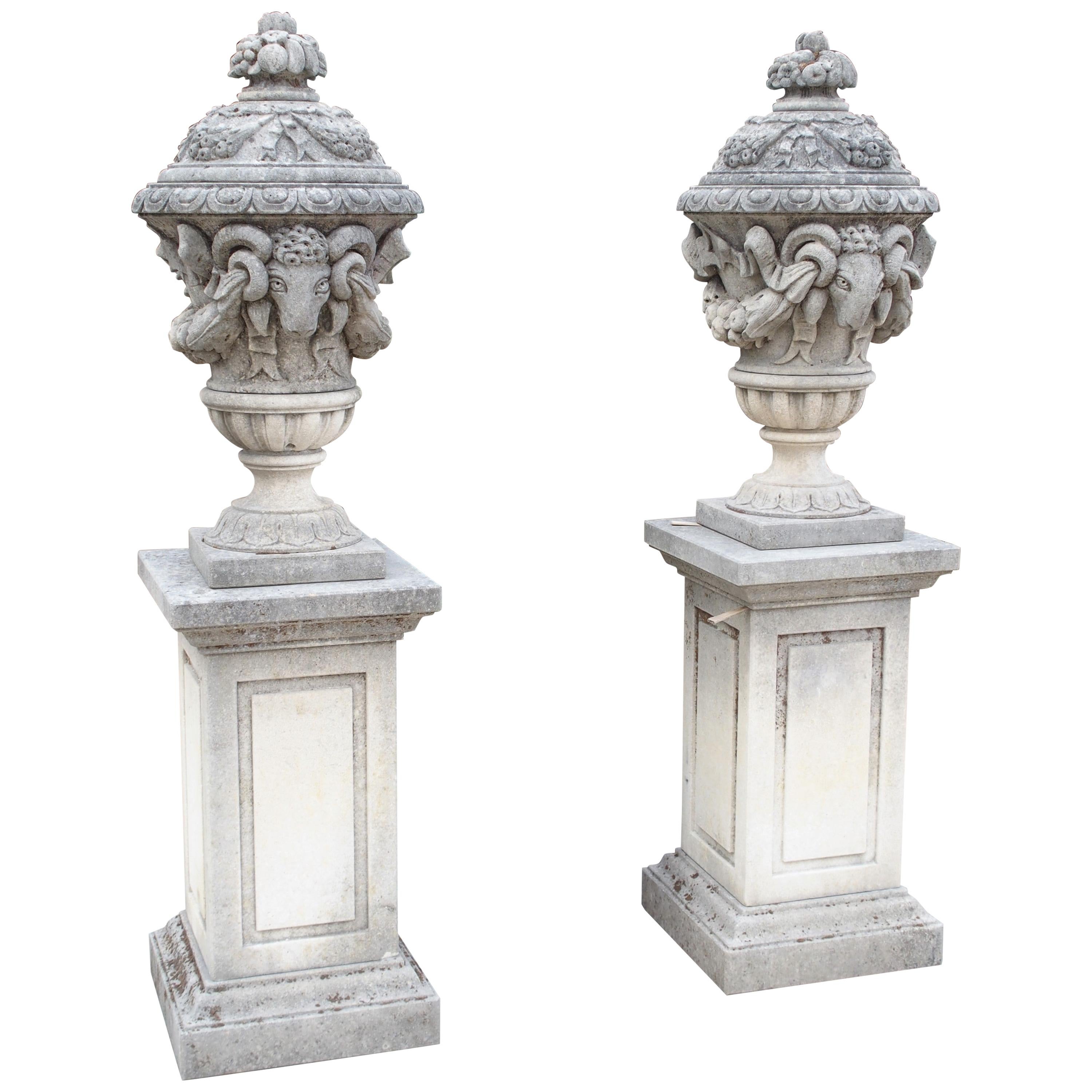 Pair of Carved Limestone Ram Heads Vases on Pedestals