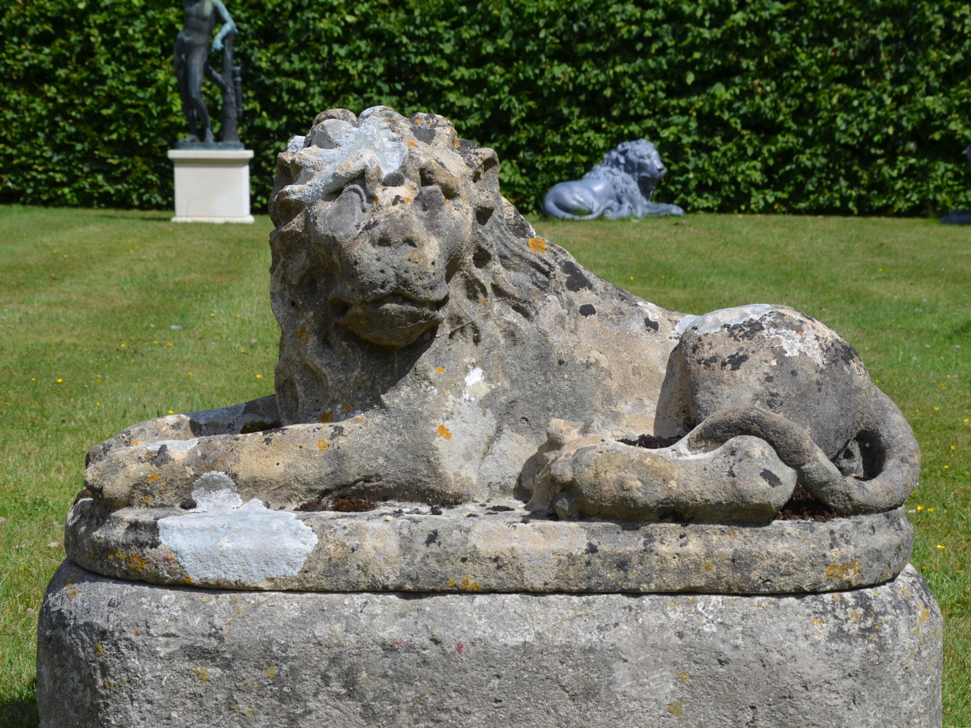 British Pair of Carved Limestone Recumbent Lions For Sale