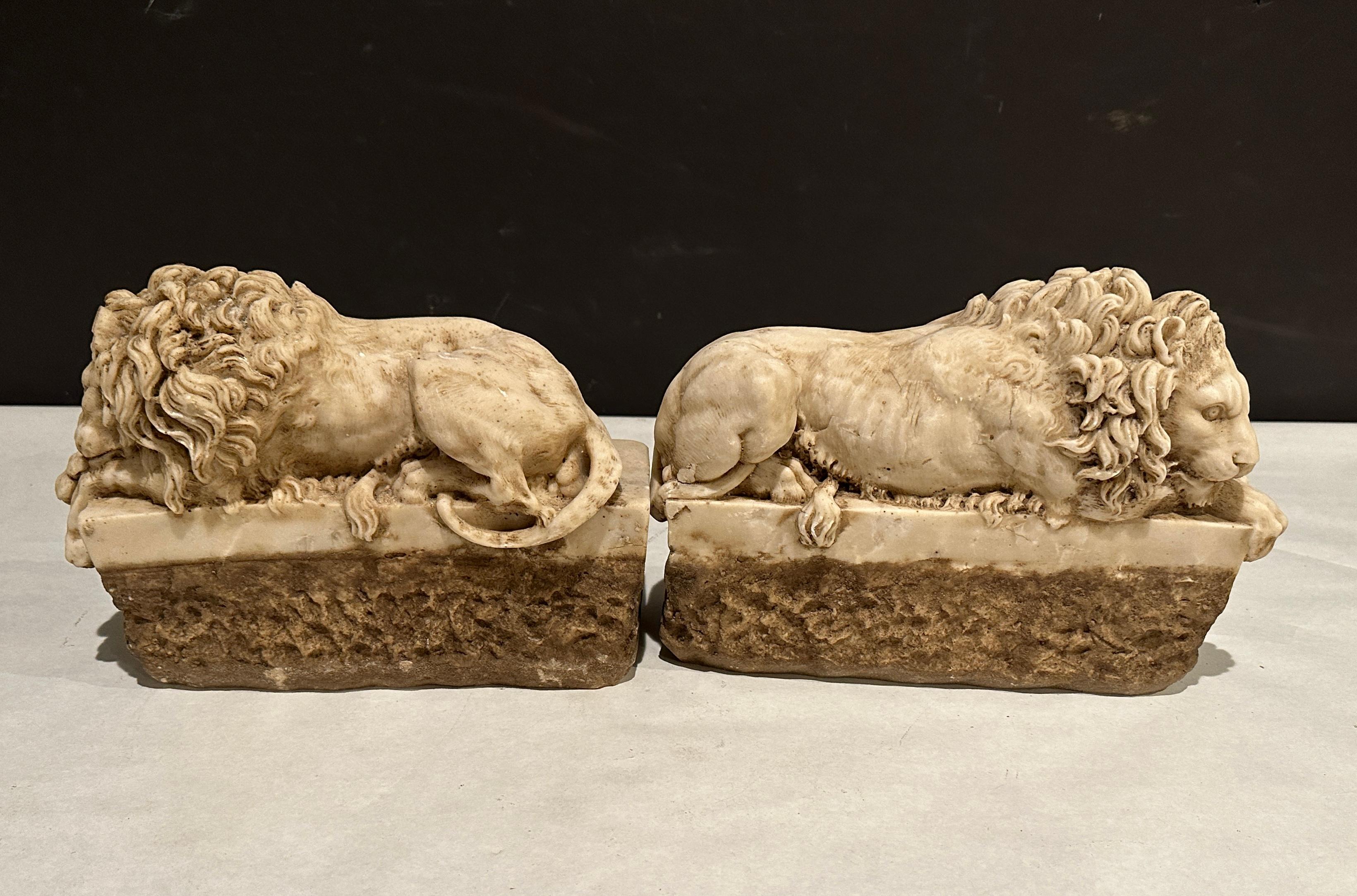 Fine quality antique carved marble recumbent lions after models by Antonio Canova. Architectural elements most likely part of a larger element or grouping.