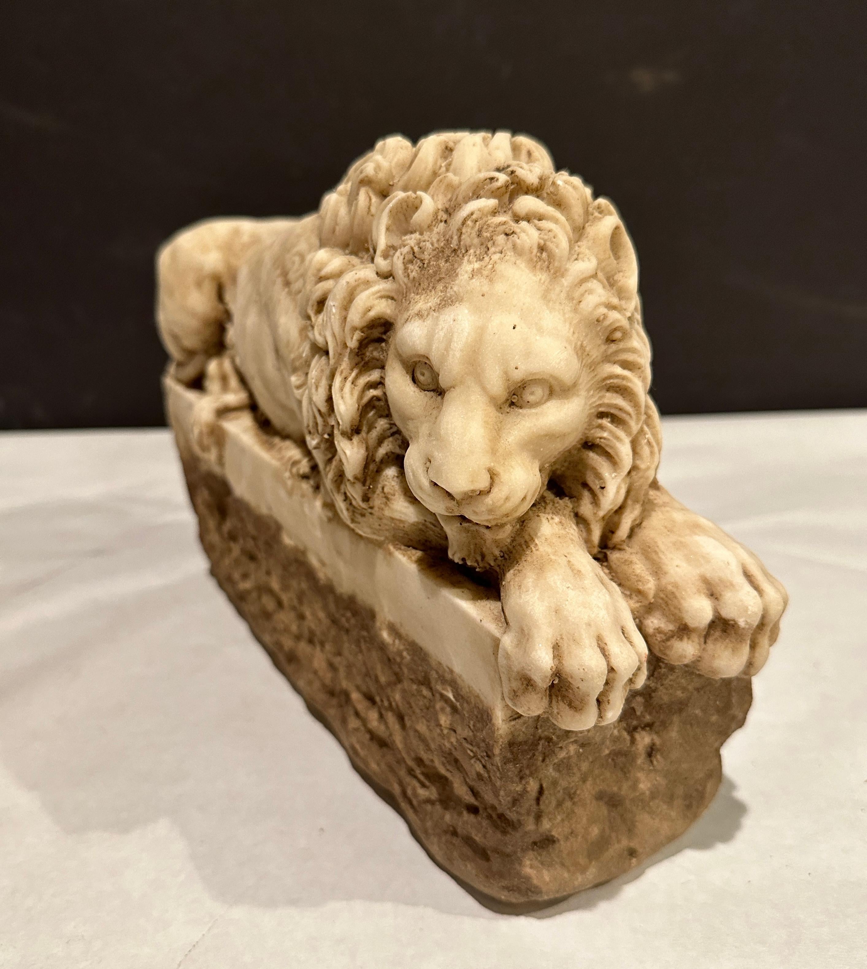 Pair of Carved Marble Recumbent Lions In Good Condition For Sale In Norwood, NJ