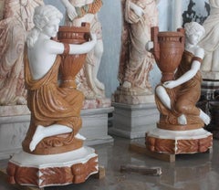 Pair of Carved Marble Water Carrier Sculptures