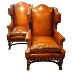 Used Pair of Carved Oak and Leather Wing Chairs