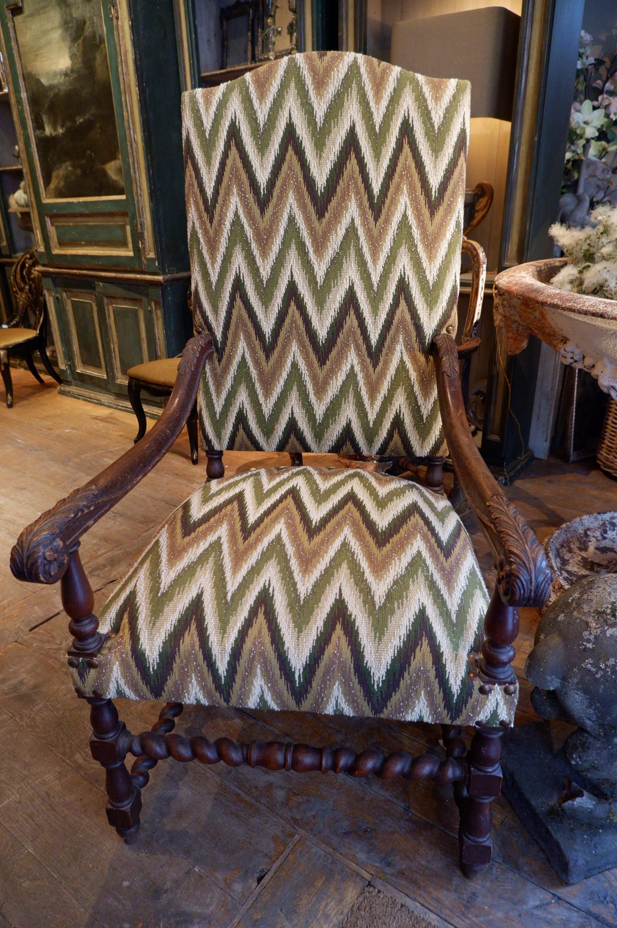 Louis XIII Pair of carved oak armchairs with scrolls and flamed fabric For Sale