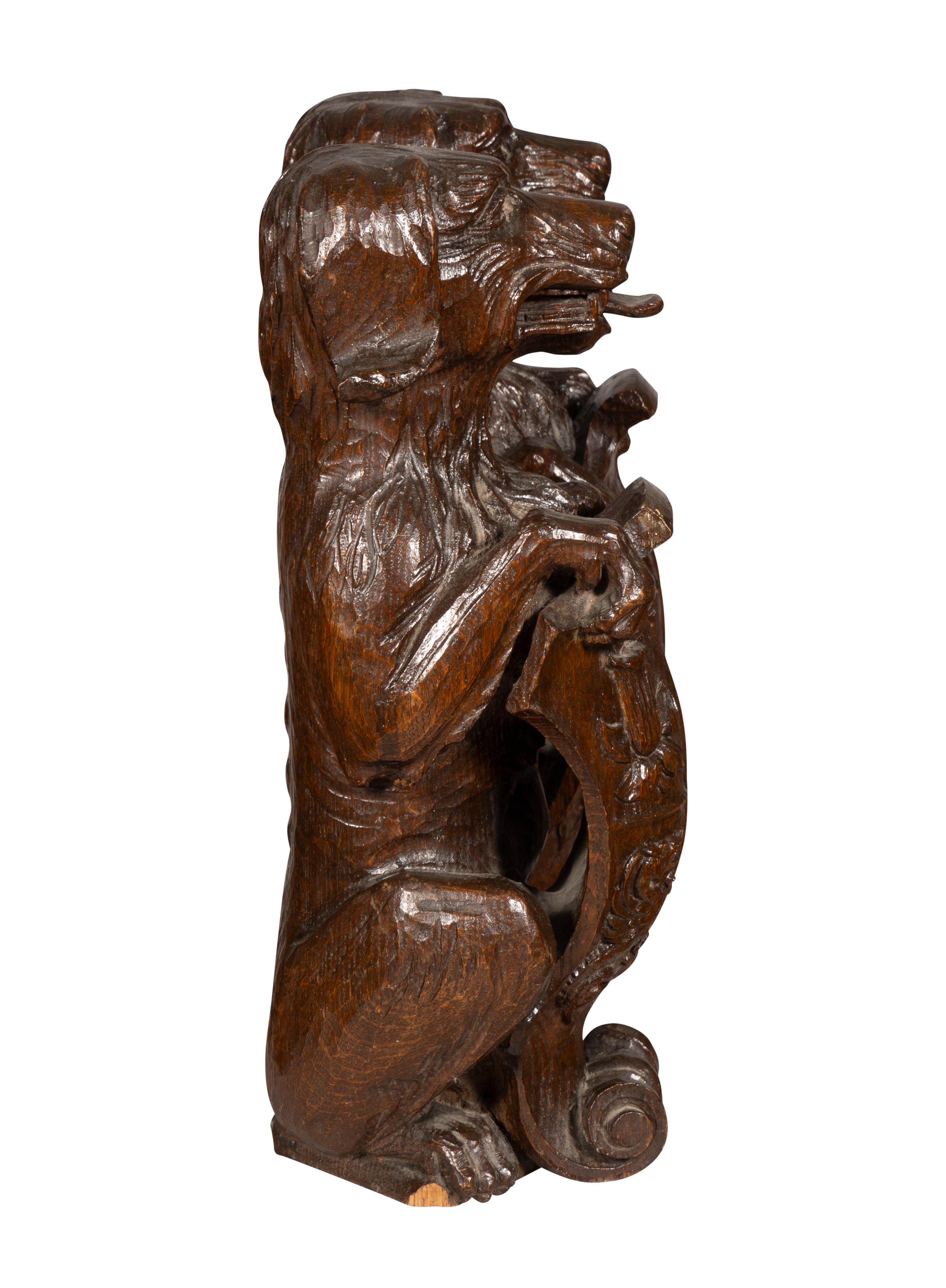 Victorian Pair Of Carved Oak Figures Of Seated Dogs With Shields For Sale