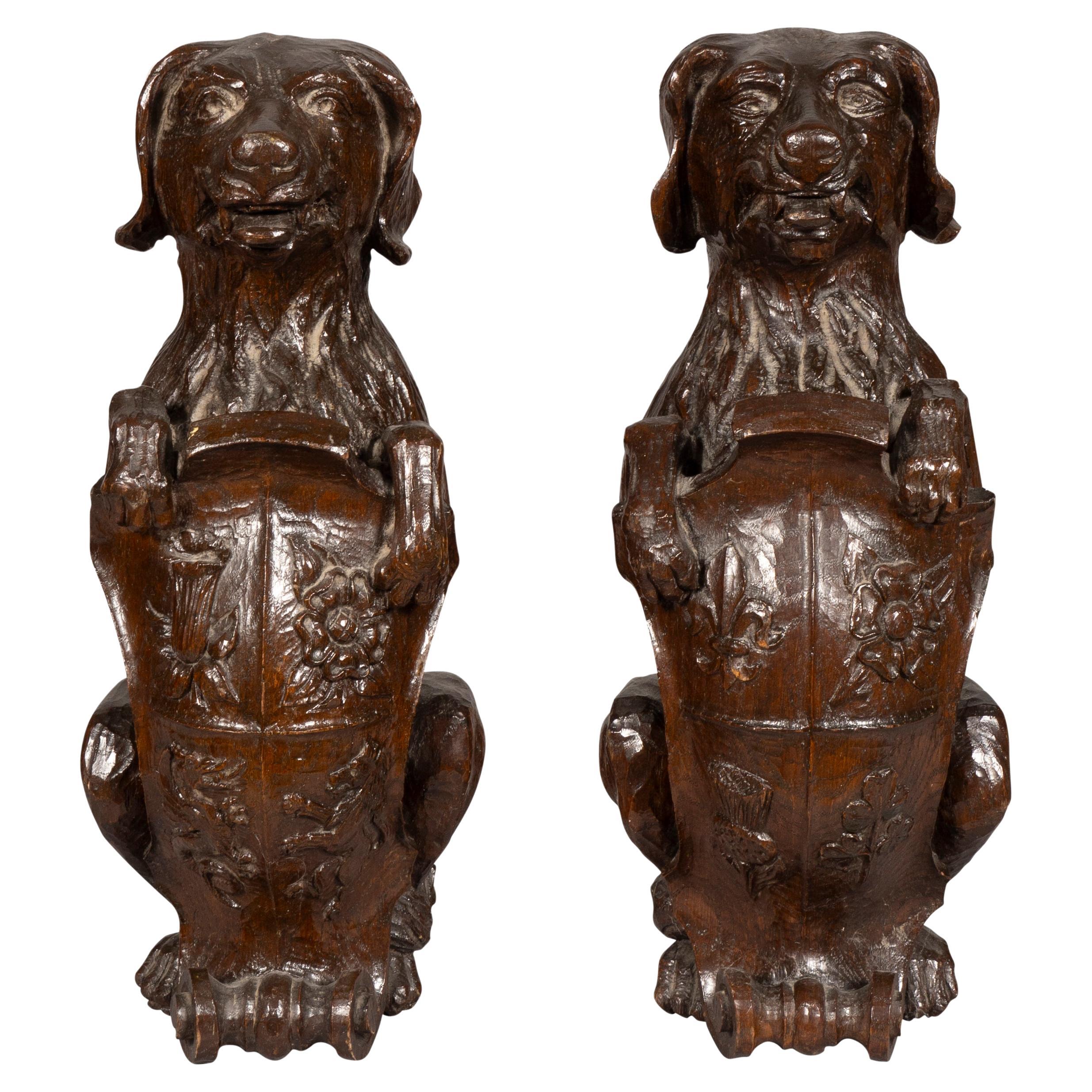 Pair Of Carved Oak Figures Of Seated Dogs With Shields For Sale