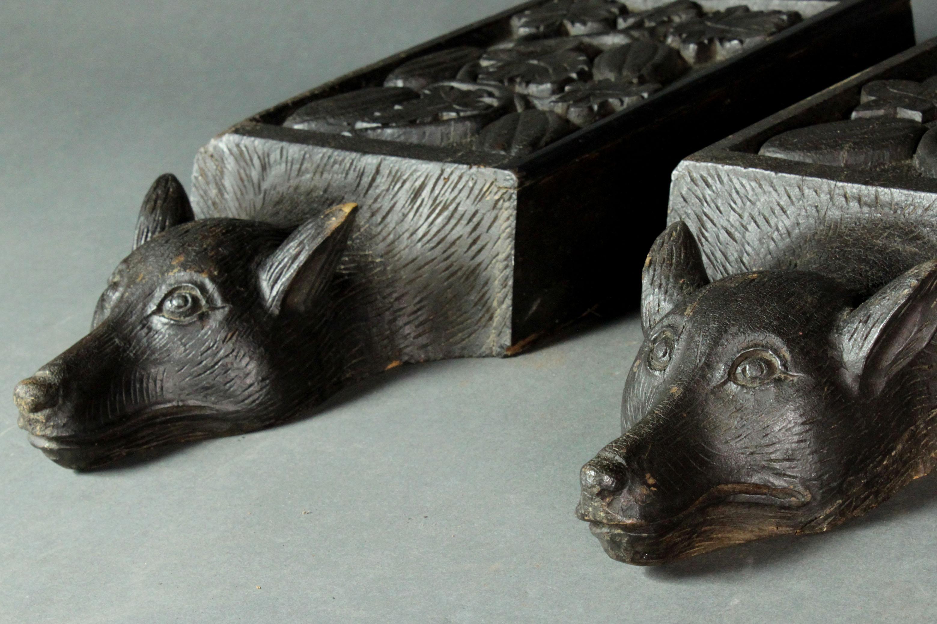 A pair of early 19th century oak corbels in their original bitumen paint. Finely carved fox heads with flowers and vine leaves in relief.
 
