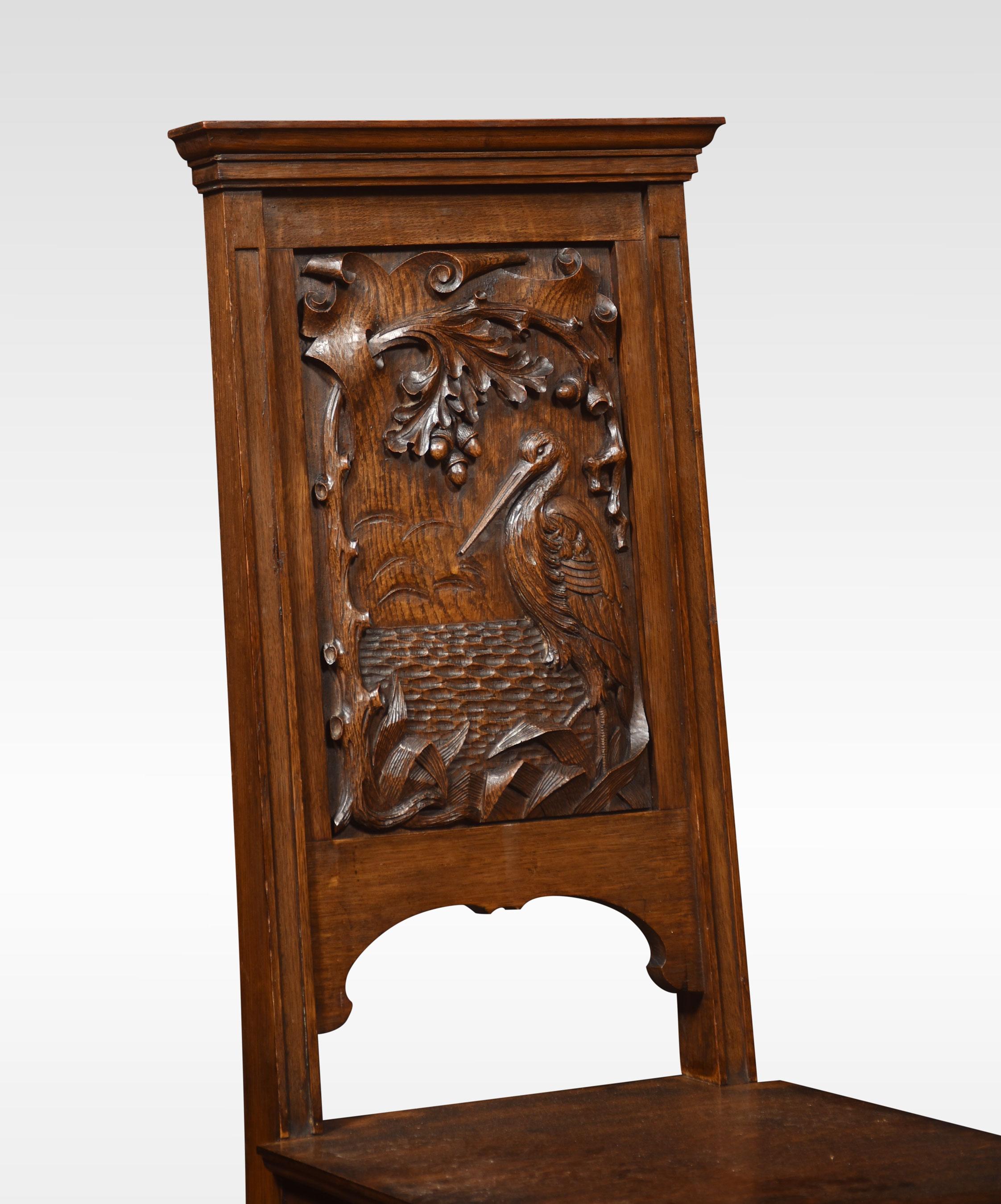 Pair of carved oak hall chairs, each having a panelled back decorated with a stork above the oak seat. Raised up on turned and blocked front legs united by stretchers.
Dimensions
Height 45 inch height to seat 18.5 inch
Width 18.5 inch
Depth 19.5