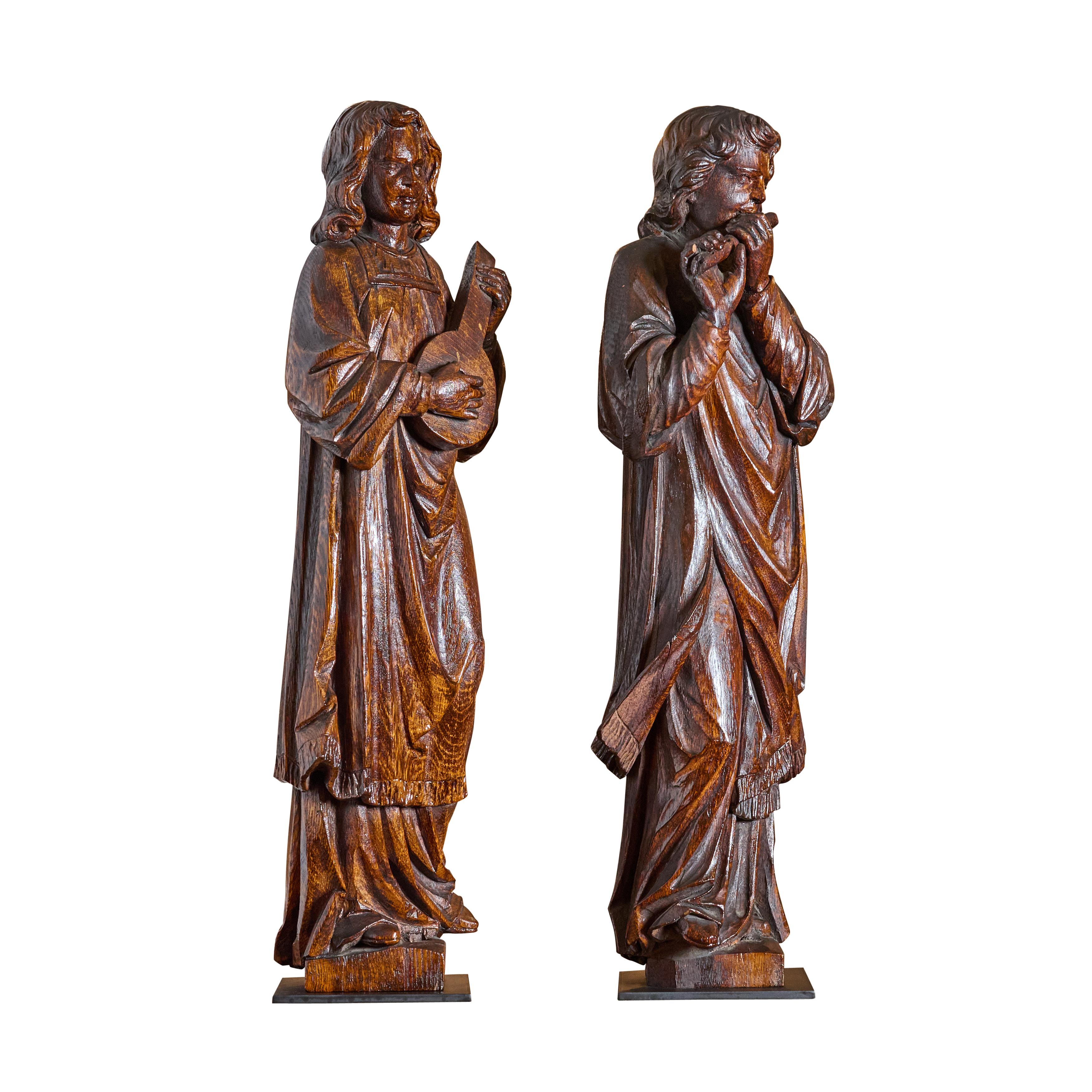 Pair of carved oak musicians. Includes new custom iron bases. Great quality.

