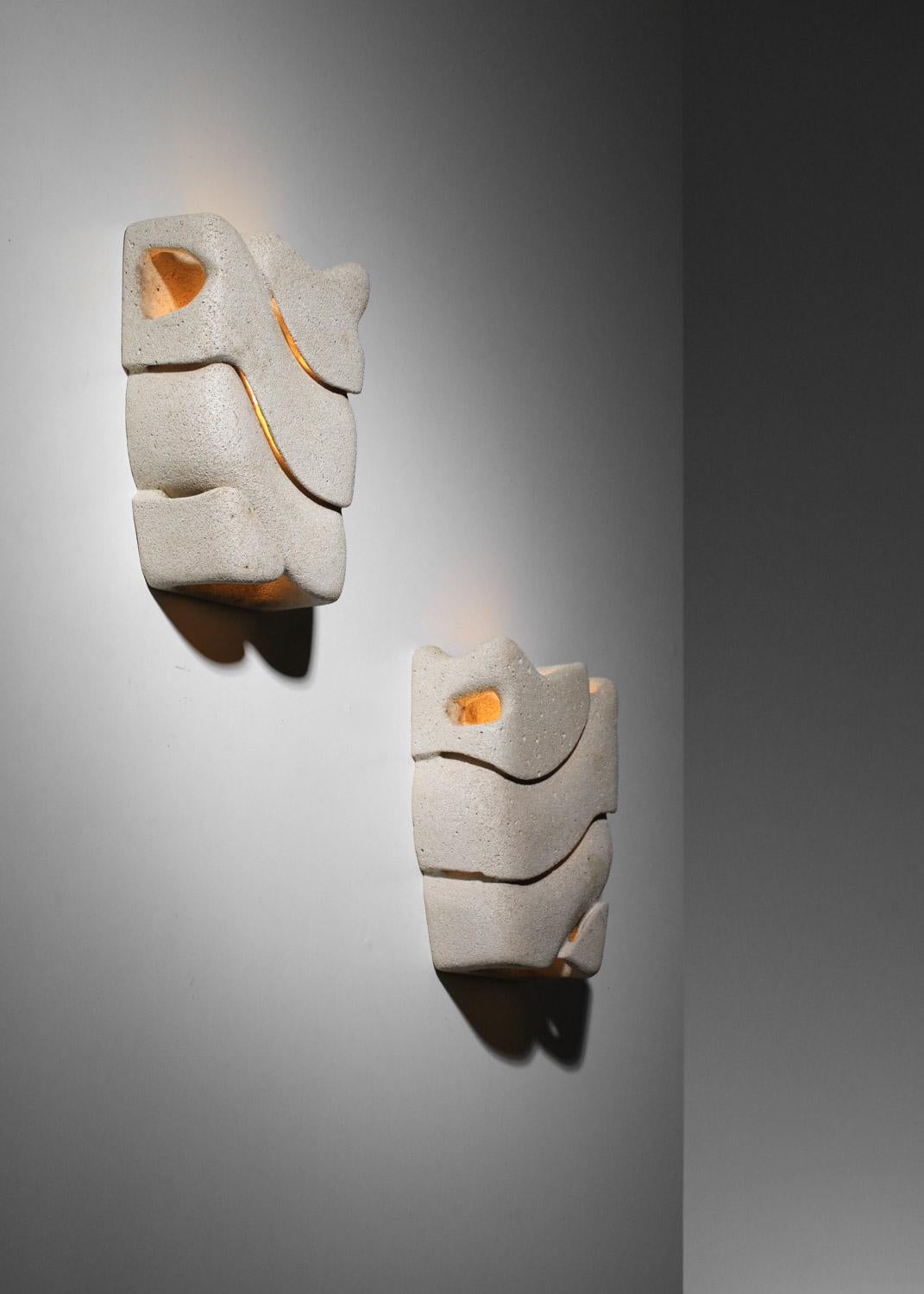 Organic Modern Pair of carved reconstituted stone wall lights, unsigned For Sale