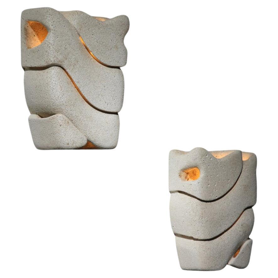 Pair of carved reconstituted stone wall lights, unsigned For Sale