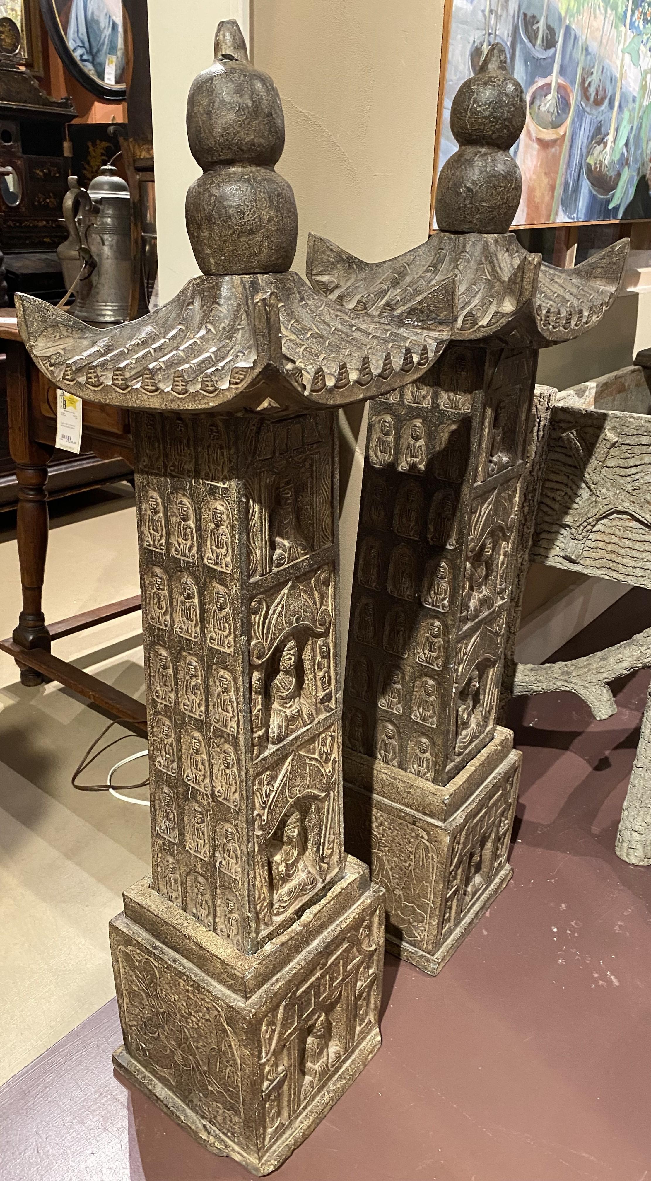 A fine pair of carved stone Chinese pagodas with square bases decorated with Buddha figures on the front, and incised figures around each side. Each pagoda can easily be disassembled for transport. Each date to the 20th century with great overall