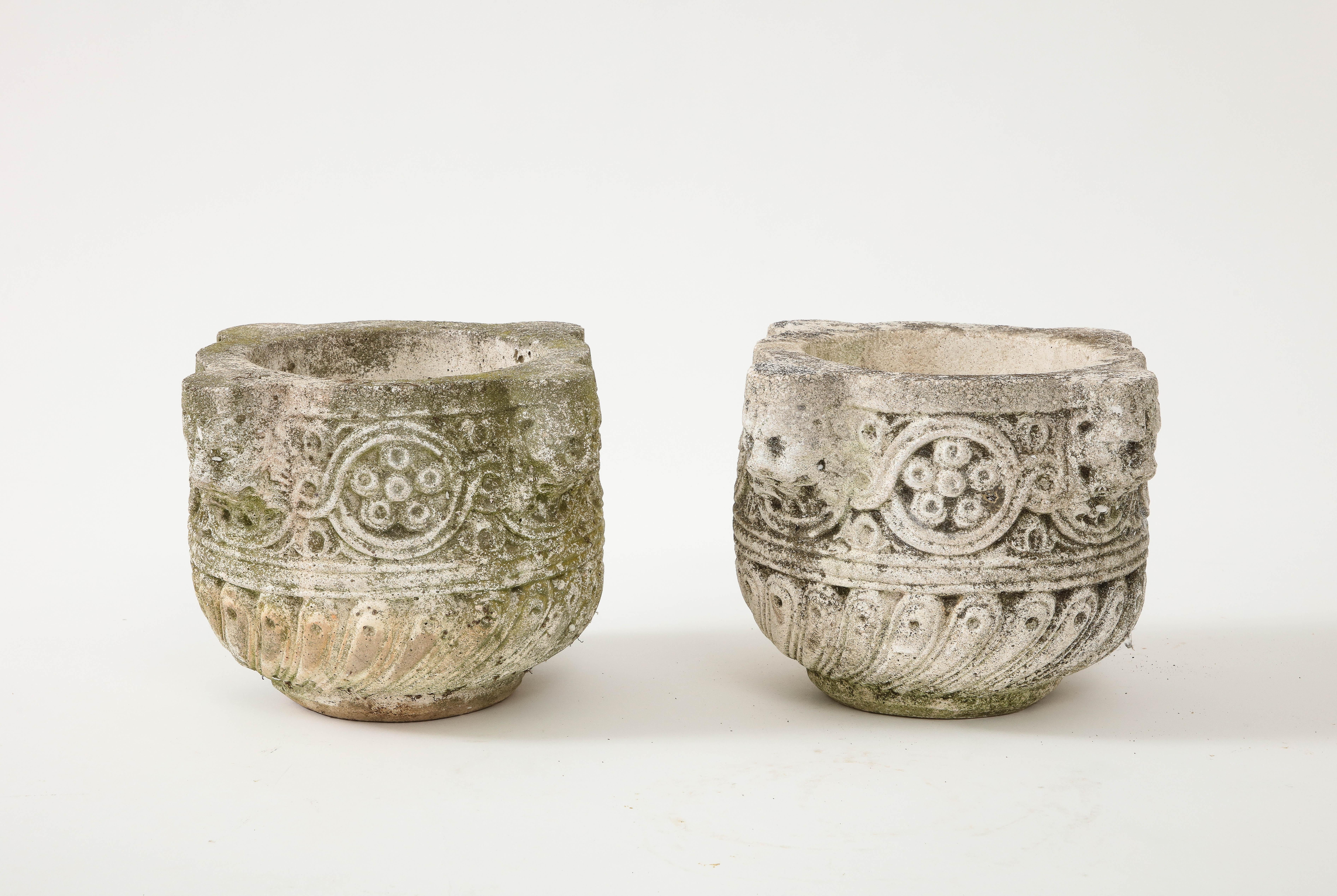 A pair of Italian eighteenth century hand-carved stone vases or jardinières with wonderful lion heads, scrolls and carved rosettes.   These vases have a natural patina from years of staying outside. Vases can be used inside or out, with or without