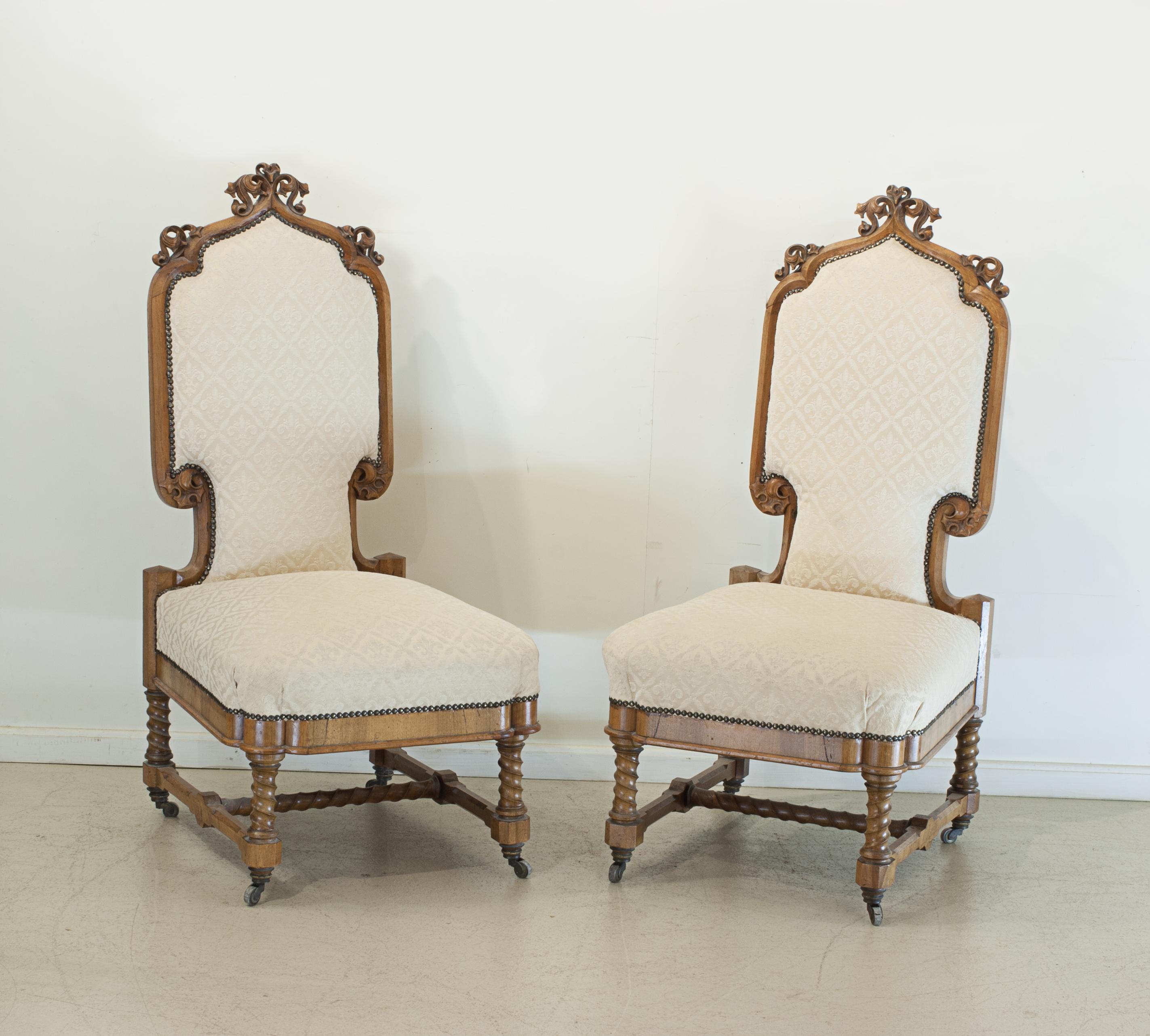 Pair of carved 19th century continental chairs.
A lovely pair of upholstered Arts & Crafts hall chairs, the carved walnut frames with crisp details, stretcher a spiral corkscrew-like form (barley twist style) as is the lower portion on the four