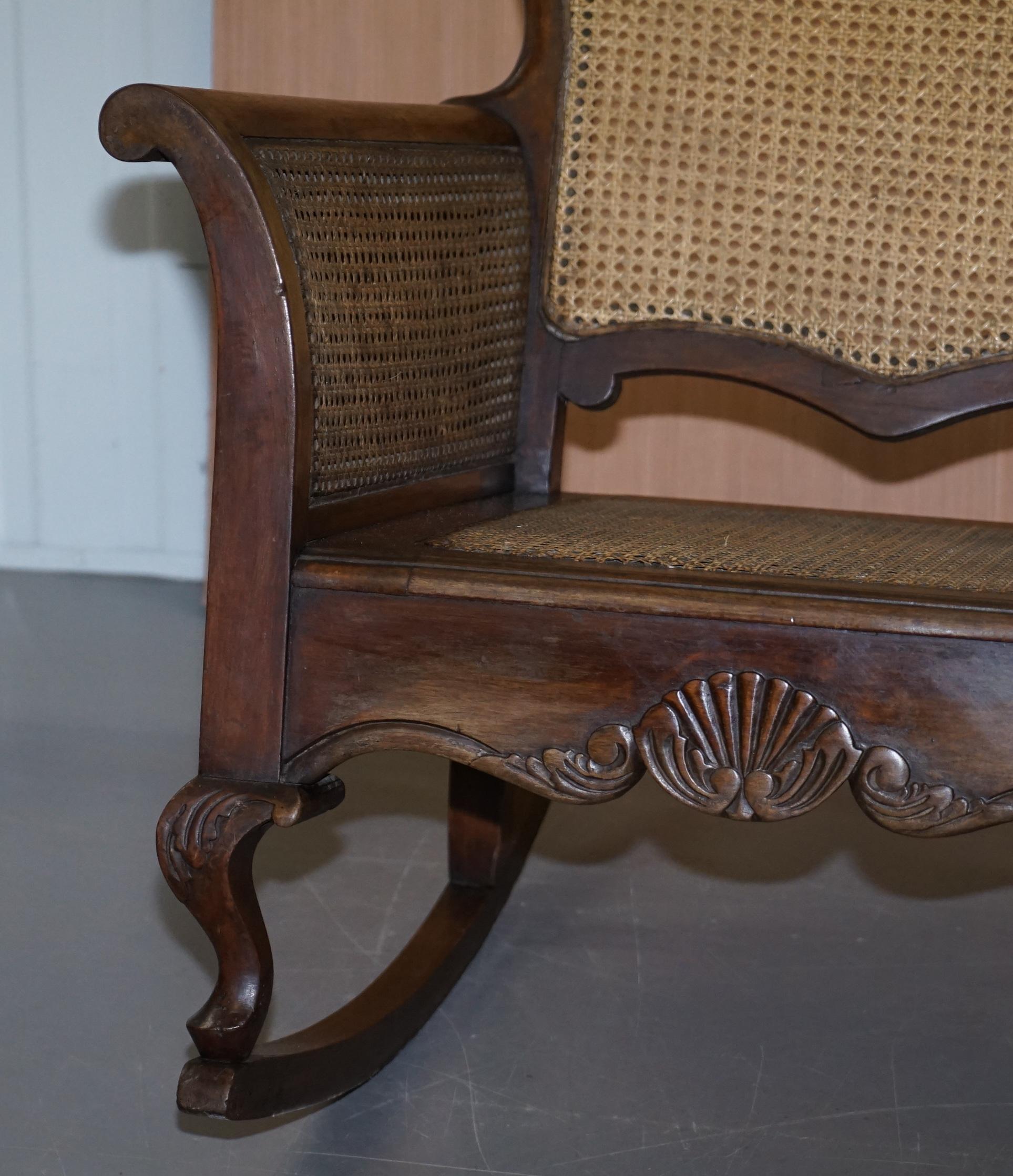 Hand-Crafted Pair of Carved Wood circa 1920s Italian Berger Rattan Rocking Armchair Chairs