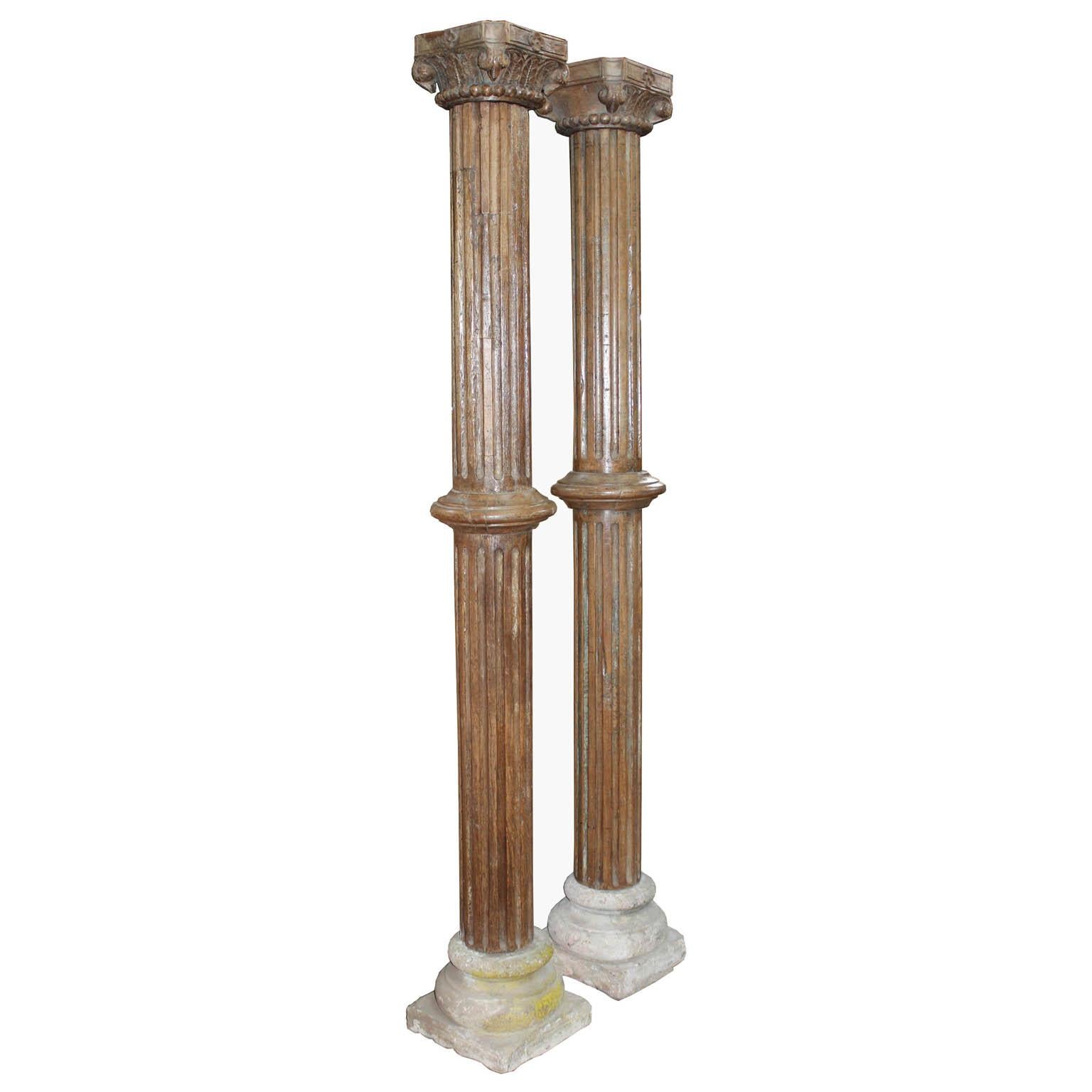 Pair of beautiful hand carved wood columns from a Haveli in Gujarat, India. The columns have carved wood capitals and stone bases. Originally used to adorn an entry in a traditional Indian Haveli, circa 1900. Assembly required.