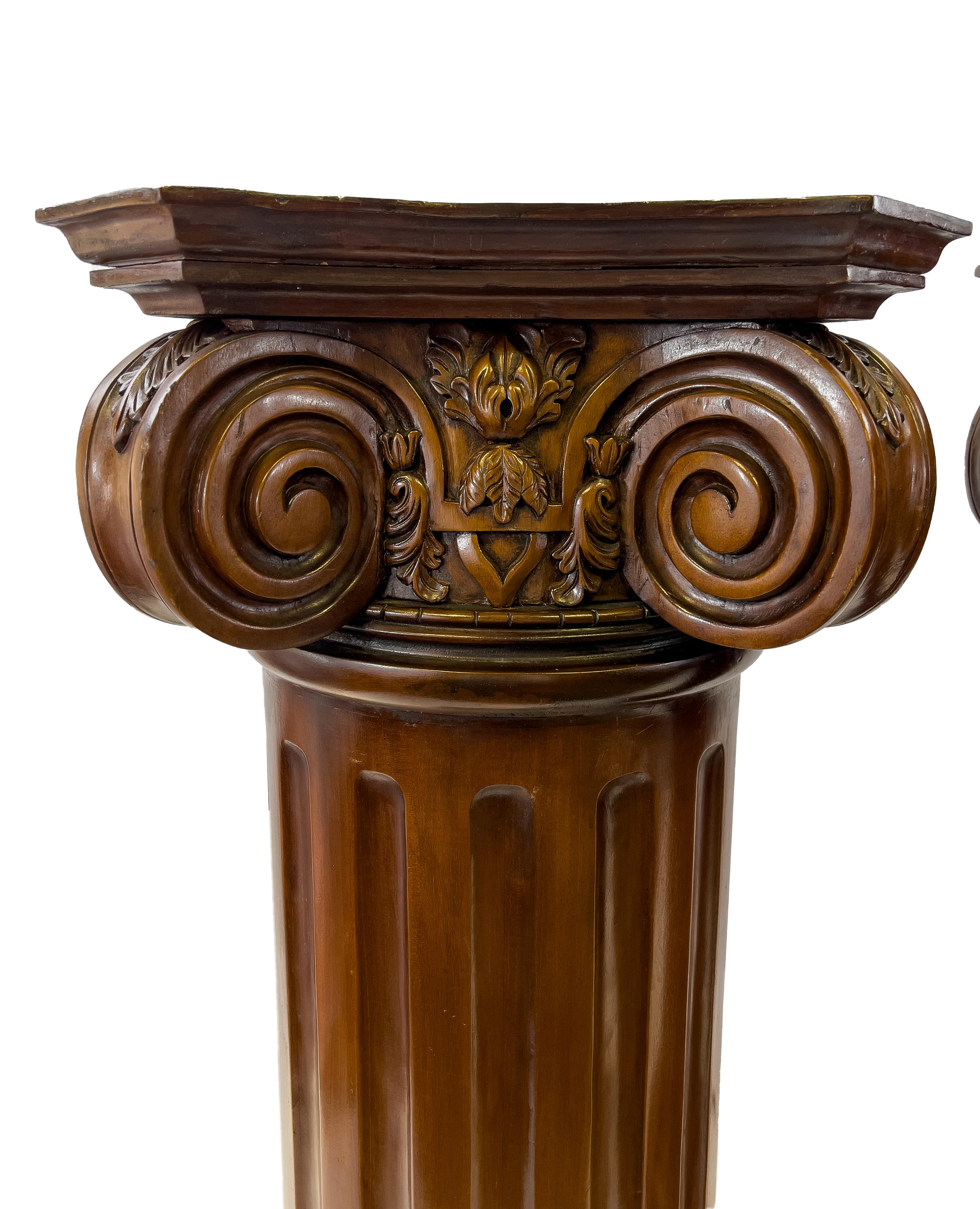Classical carved wood columns pedestals in leafy scrollwork. 
 