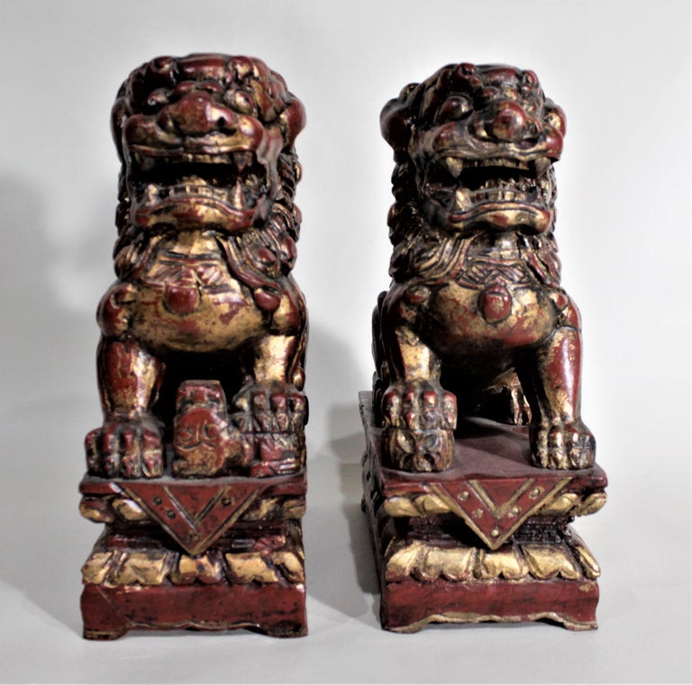Pair of Carved Wood and Gilt Finished Chinese Foo Dog Figurines or